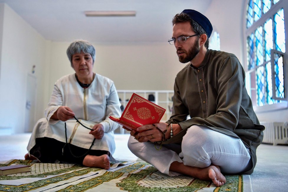 Seyran Ates listens as openly gay French imam Ludovic-Mohamed Zahed reads verses of the Koran