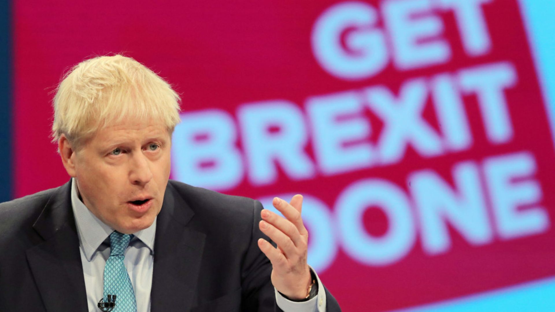 Boris Johnson in front of a 'get Brexit done' screen. - Credit: Danny Lawson/PA Wire