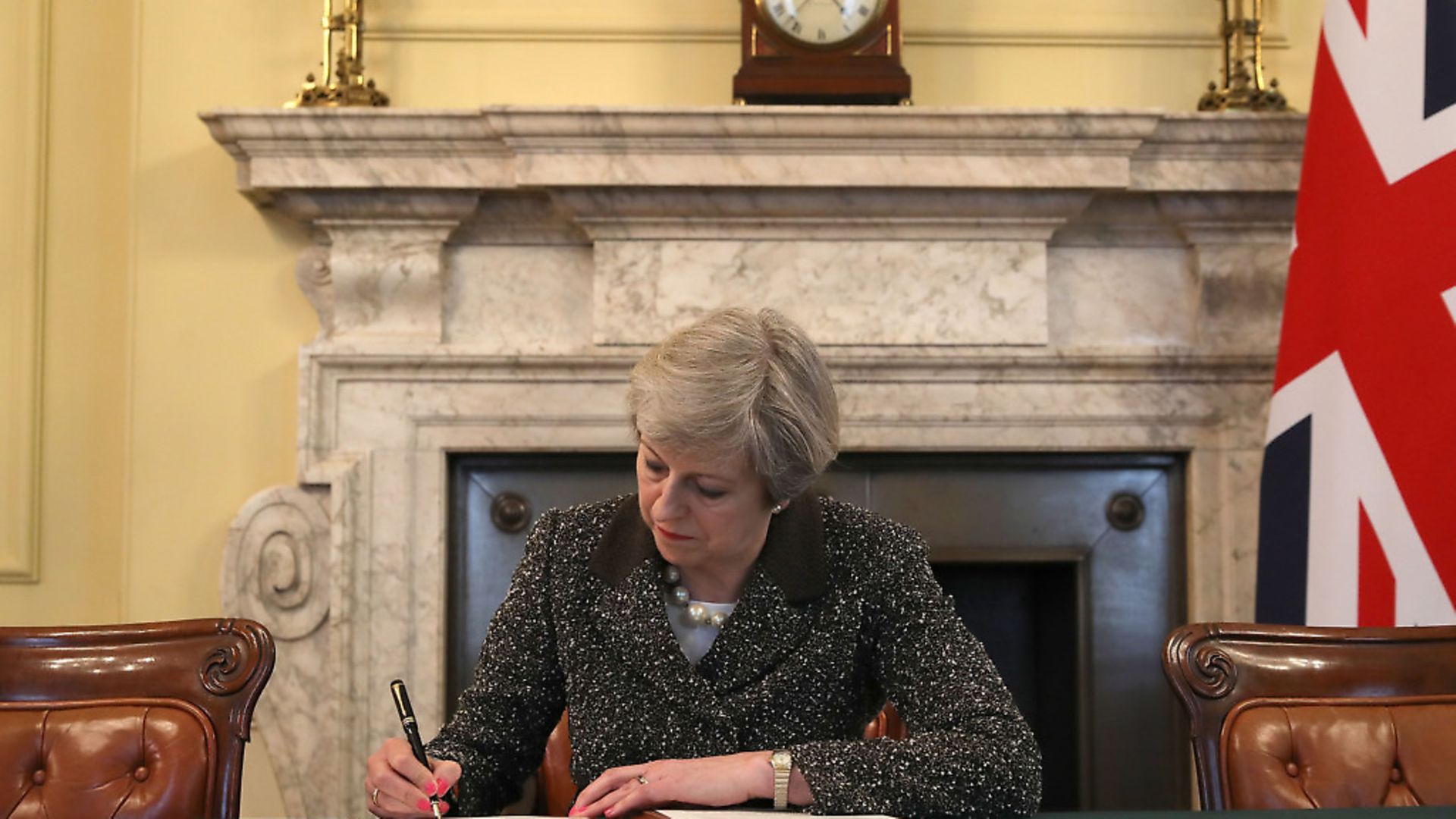 Theresa May signs the letter notifying the EU that Article 50 has been triggered - Credit: PA