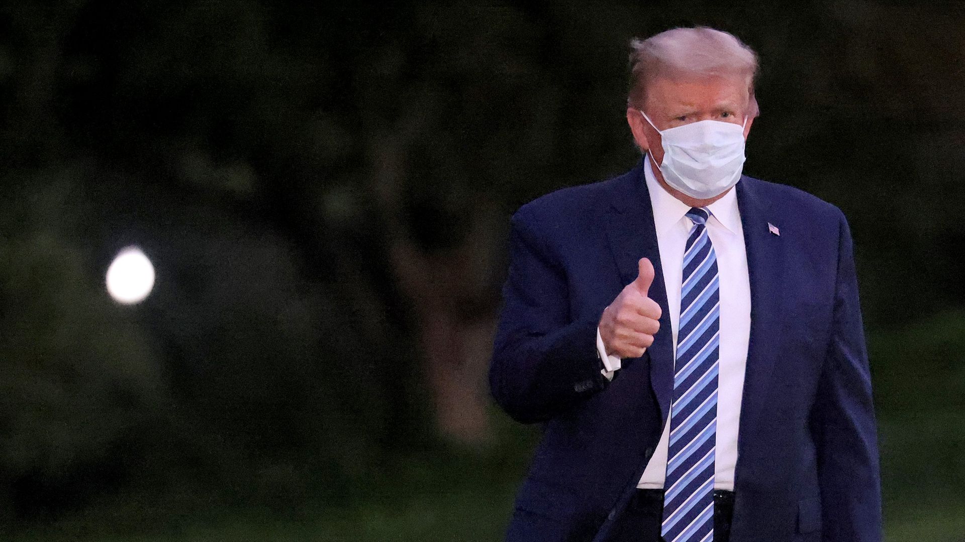 Donald Trump gestures upon return to the White House after his bout of coronavirus - Credit: Getty Images