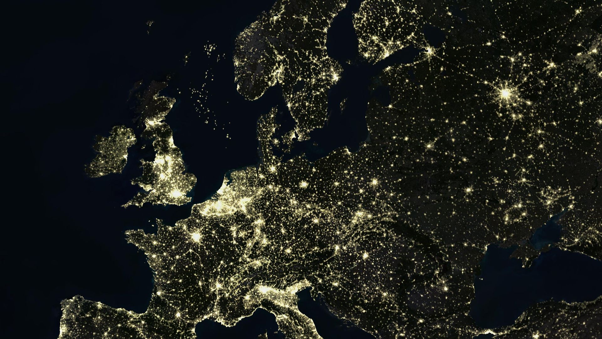 True colour satellite image of Europe and the UK at night. This image in Lambert Conformal Conic projection was compiled from data acquired by LANDSAT 5 & 7 satellites. - Credit: Universal Images Group via Getty
