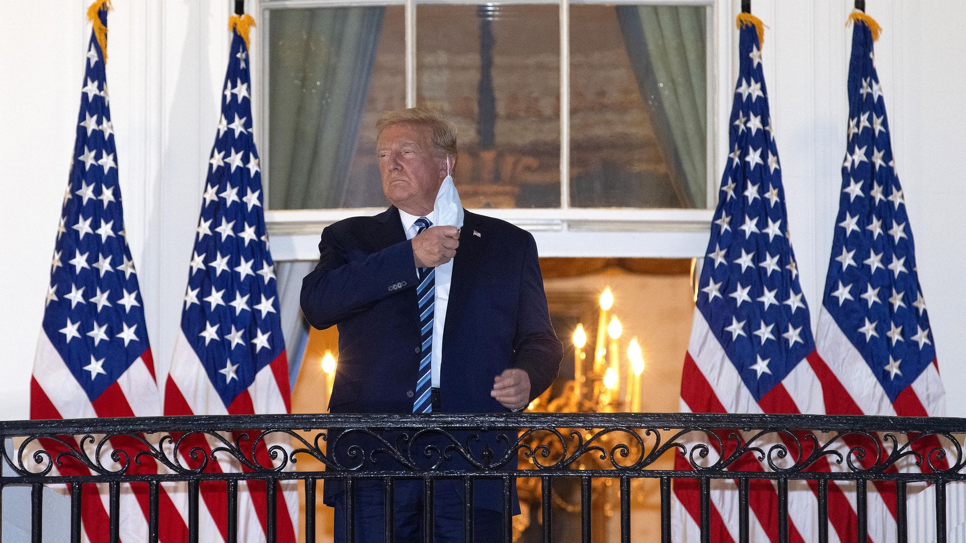 Donald Trump removes his mask upon return to the White House from hospital. Trump spent three days hospitalized for coronavirus. - Credit: Getty Images