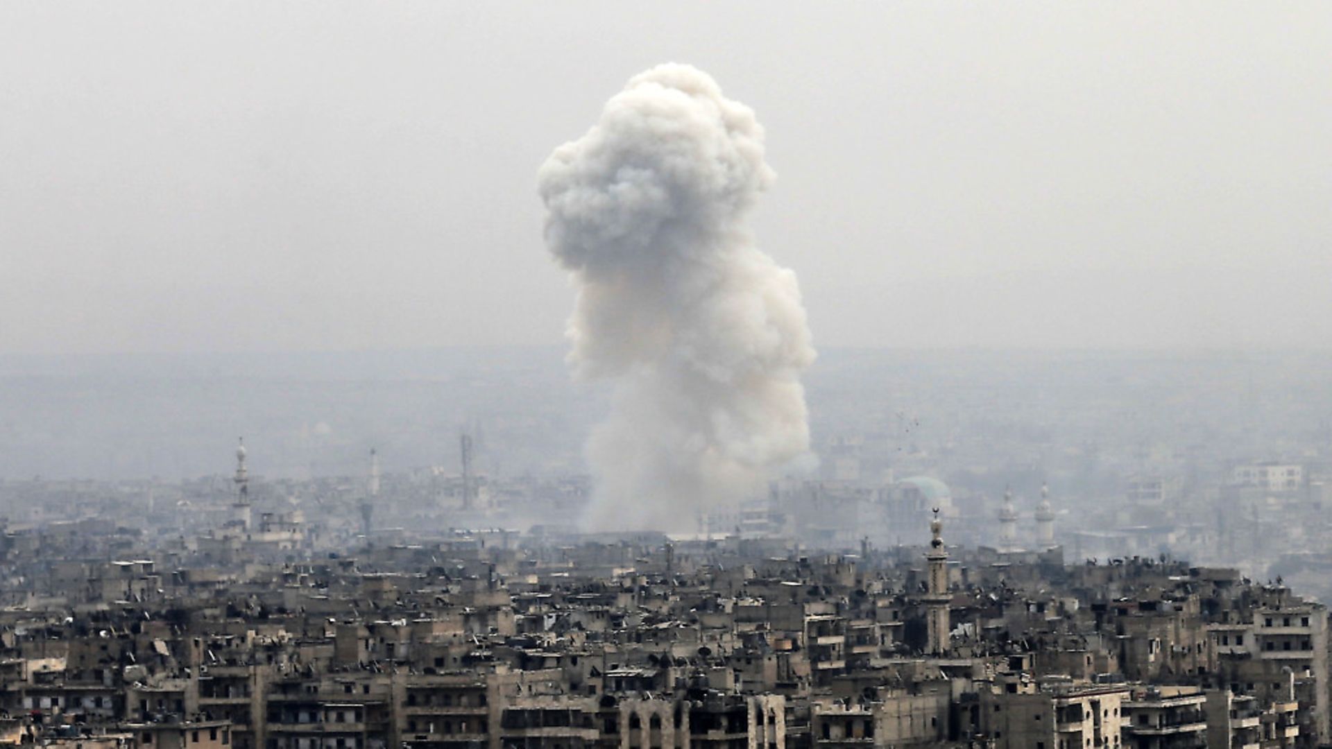 Smoke rises following a Syrian government air strike on rebel positions, in eastern Aleppo, Syria on December 5, 2016. Photo: AP/PA Hassan Ammar. - Credit: AP/Press Association Images