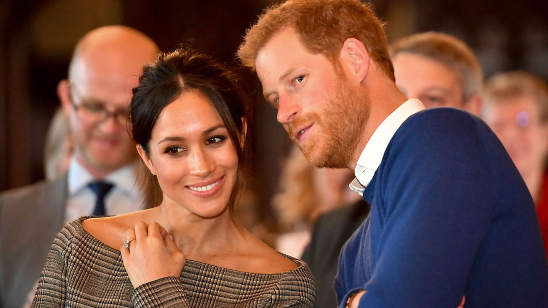 Prince Harry whispers to Meghan Markle as they watch a dance performance by Jukebox Collective in the banqueting hall during a visit to Cardiff Castle. Photo: PA Wire/PA Images