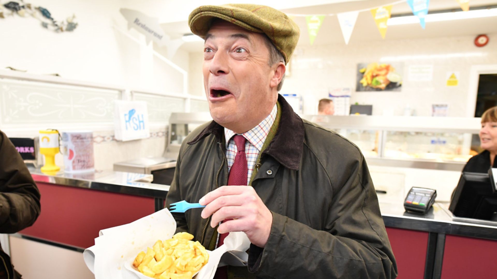 Brexit Party leader Nigel Farage eats fish and chips in Whitehaven. - Credit: Jeff J Mitchell/Getty Images.