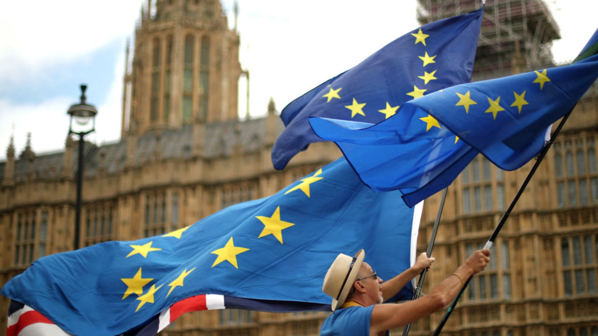 Anti-Brexit demonstrators wave European and Union flags outside the Houses of Parliament in London - Credit: PA Wire/PA Images