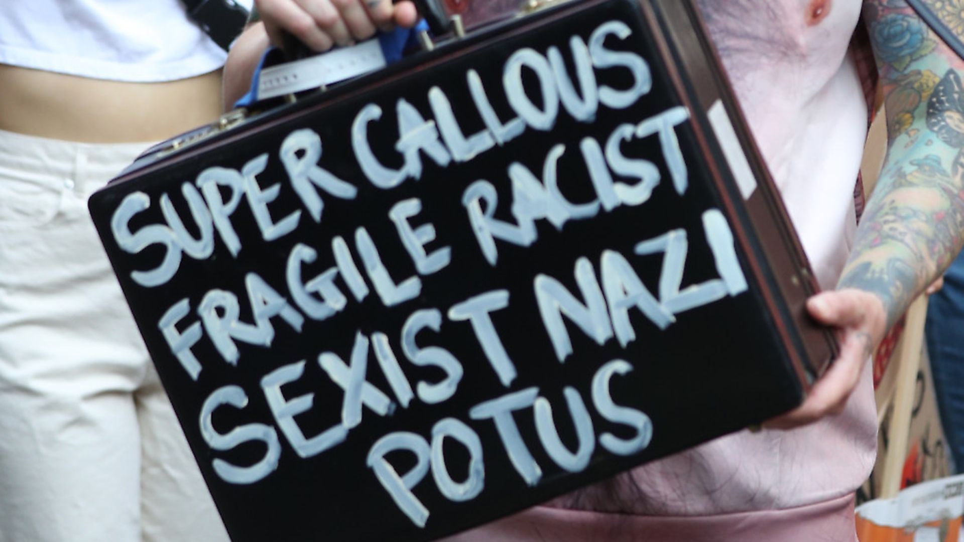 A placard being held at the Trump protests. Photograph: Gareth Fuller/PA. - Credit: PA