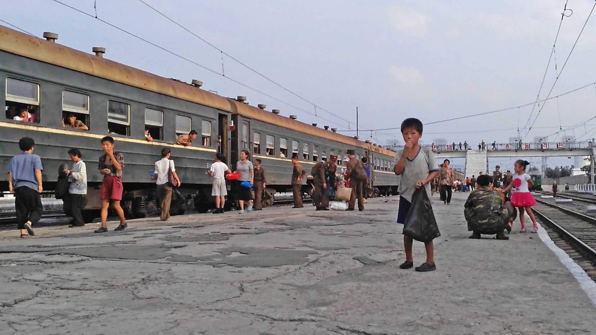 HAMHUNG, NORTH KOREA - AUGUST 21: A little boy begs for food on the platform in Hamhung Railway Station on August 21, 2015 in Hamhung, North Korea. North and South Korea today came to an agreement to ease tensions following an exchange of artillery fire at the demilitarized border last week. (Photo by Xiaolu Chu/Getty Images) - Credit: Getty Images
