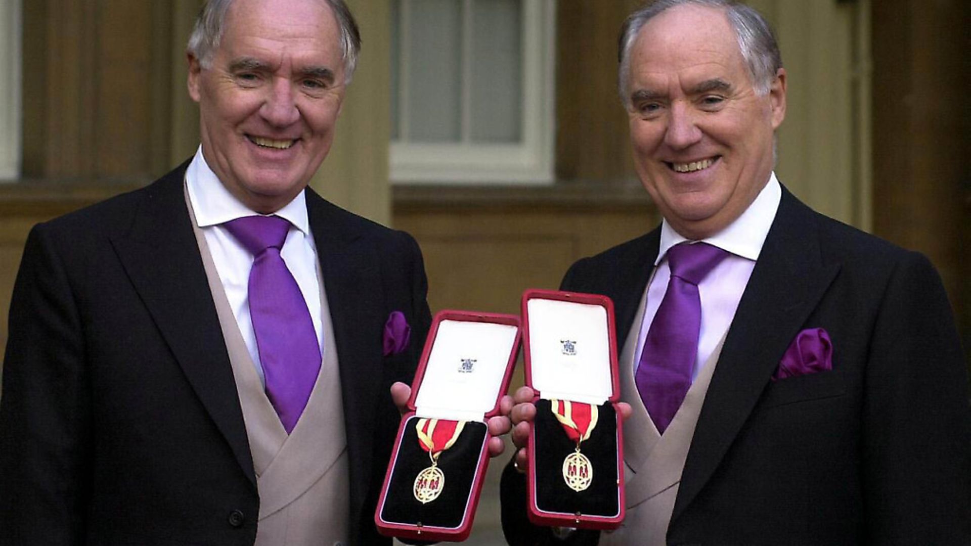 Multi-millionaires Sir David Barclay (left) and his twin brother Sir Frederick after receiving their knighthoods from the Queen at Buckingham Palace. Picture: PA - Credit: PA Archive/PA Images