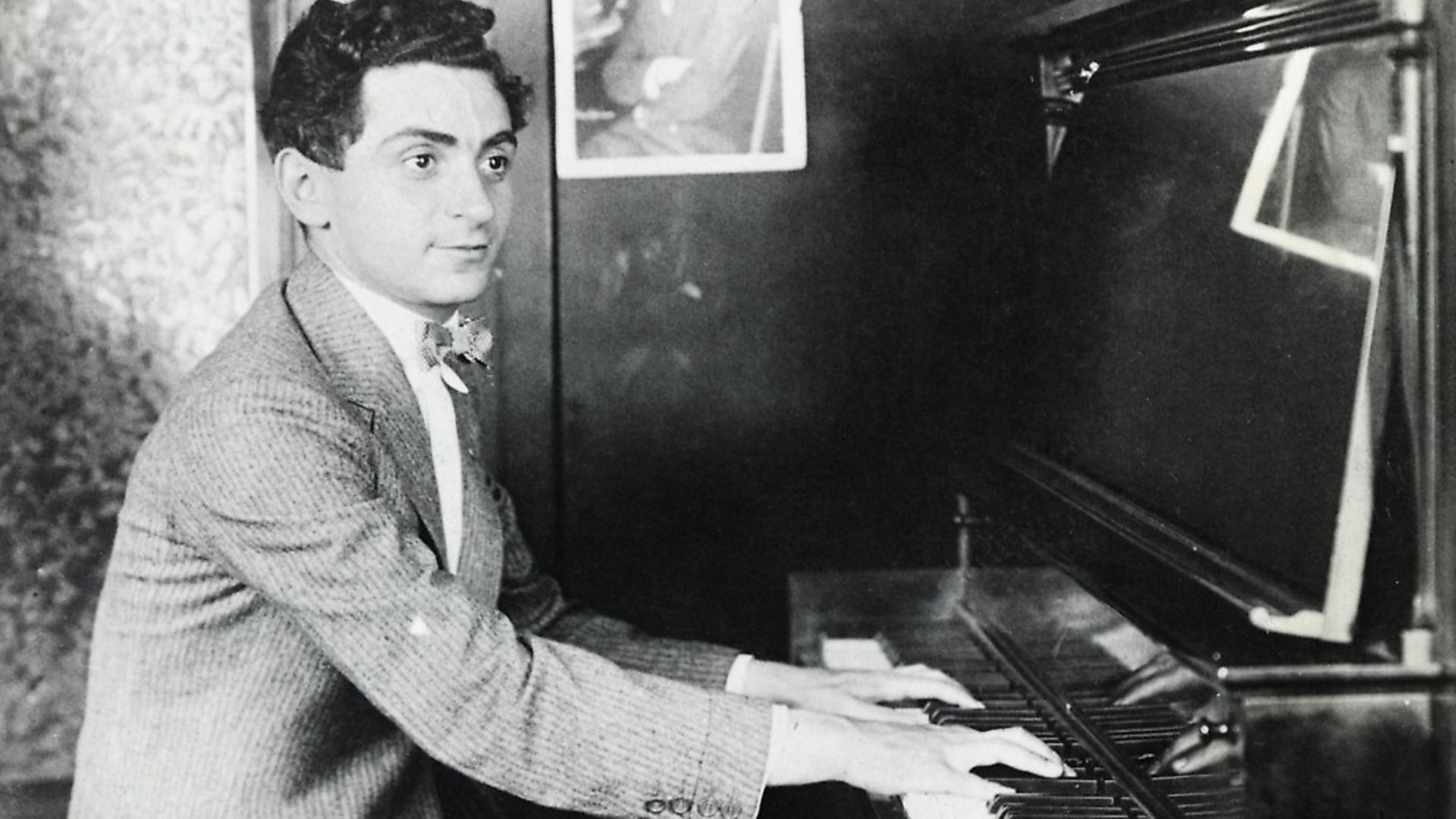 Composer Irving Berlin is shown seated at a piano, playing. Picture: George Rinhart/Corbis via Getty Images - Credit: Corbis via Getty Images