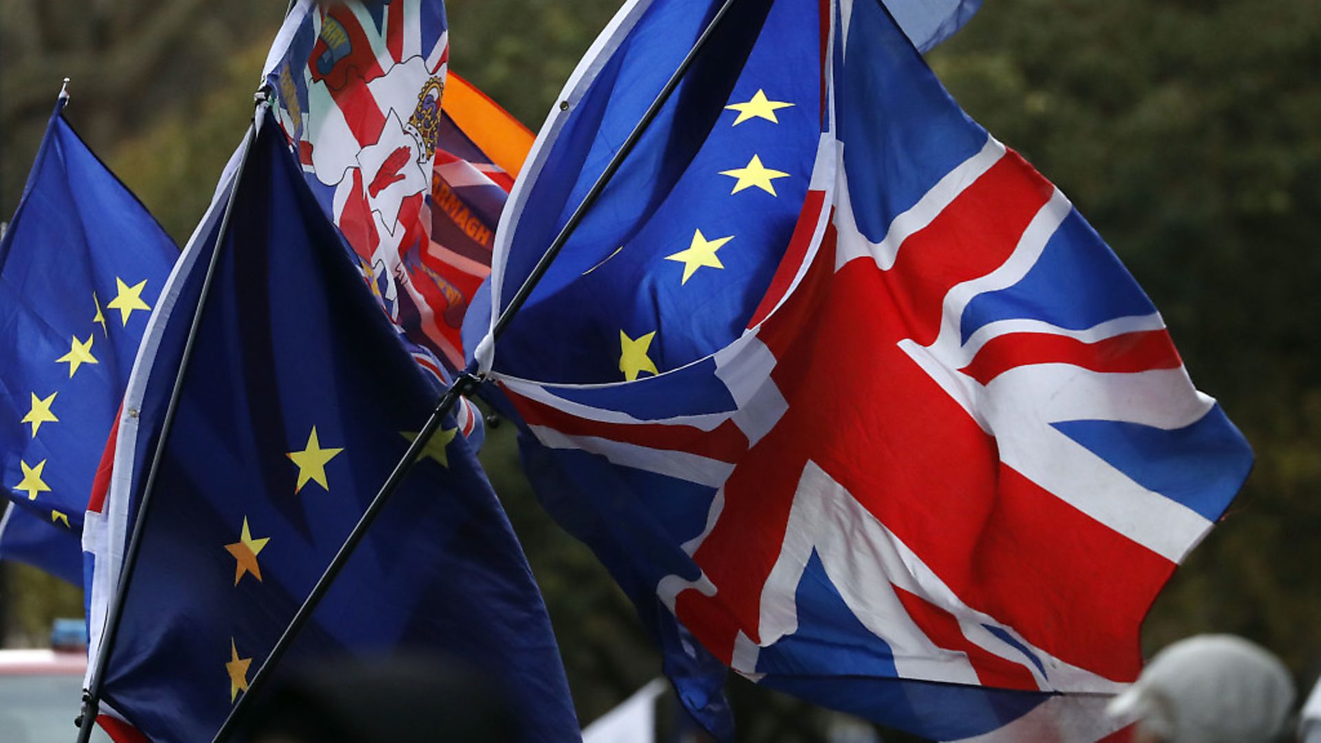 Flags fly opposite the Houses of Parliament as anti-Brexit demonstrators protest in London. Photograph: AP Photo/Frank Augstein. - Credit: AP