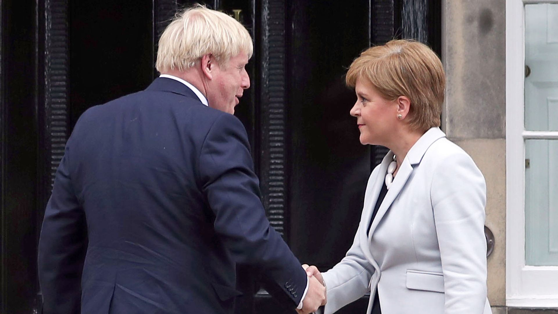 Scotland's first minister Nicola Sturgeon welcoming prime minister Boris Johnson outside Bute House in Edinburgh - Credit: PA