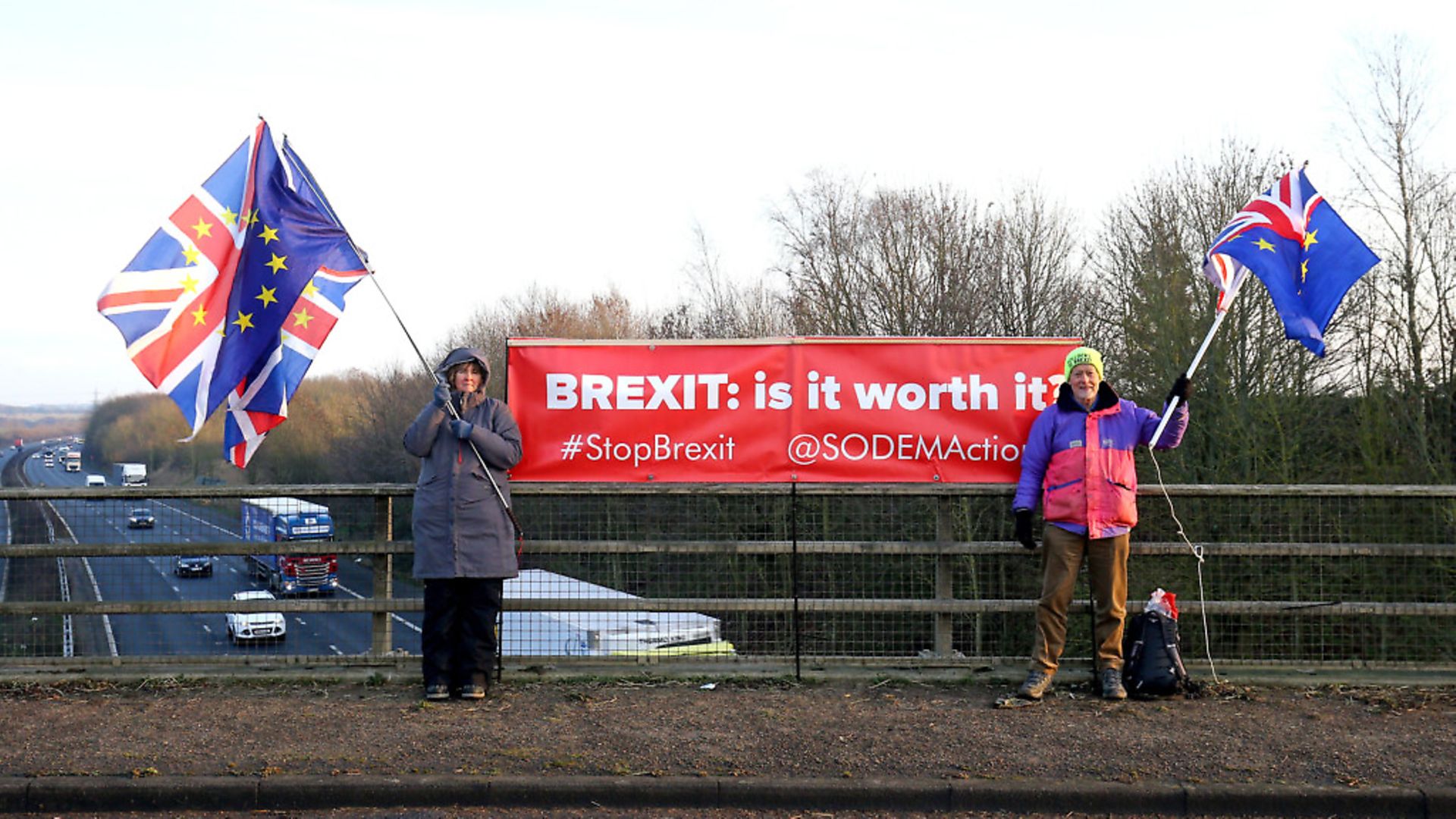 Louise Hummerstone and Hugh Riddle of the SODEM anti-Brexit group campaign above the M20 near Ashford in Kent. Photograph: Gareth Fuller/PA. - Credit: PA Wire/PA Images