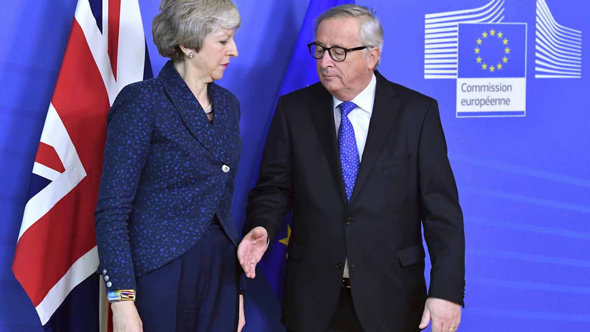 European Commission President Jean-Claude Juncker, right, prepares to shake hands with British Prime Minister Theresa May. (AP Photo/Geert Vanden Wijngaert) - Credit: AP