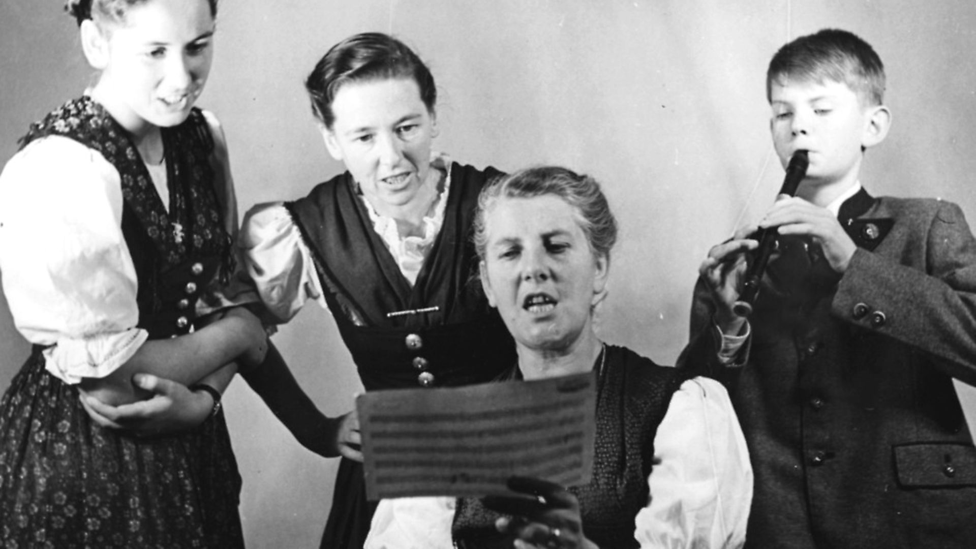 Portrait of Baroness Maria Von Trapp and three of her children, (L-R) Eleonore, Agatha and Johannes, singing from a piece of sheet music, London, circa 1950. Picture: George Konig/Keystone Features/Getty Images - Credit: Getty Images