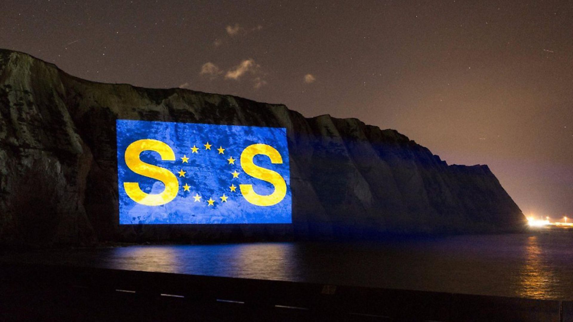 A giant SOS message is projected on to the white cliffs of Dover. Photograph: Led By Donkeys. - Credit: Archant