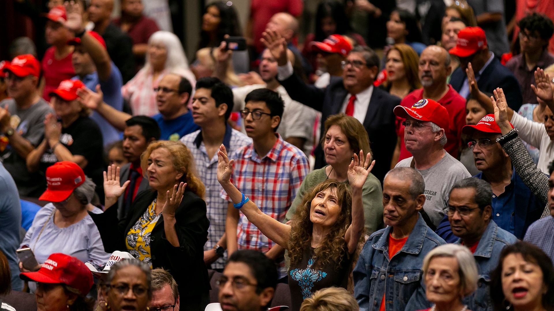 Attendees pray before President Donald Trump speaks at an ";Evangelicals for Trump" campaign rally in Miami. - Credit: Miami Herald/Getty Images