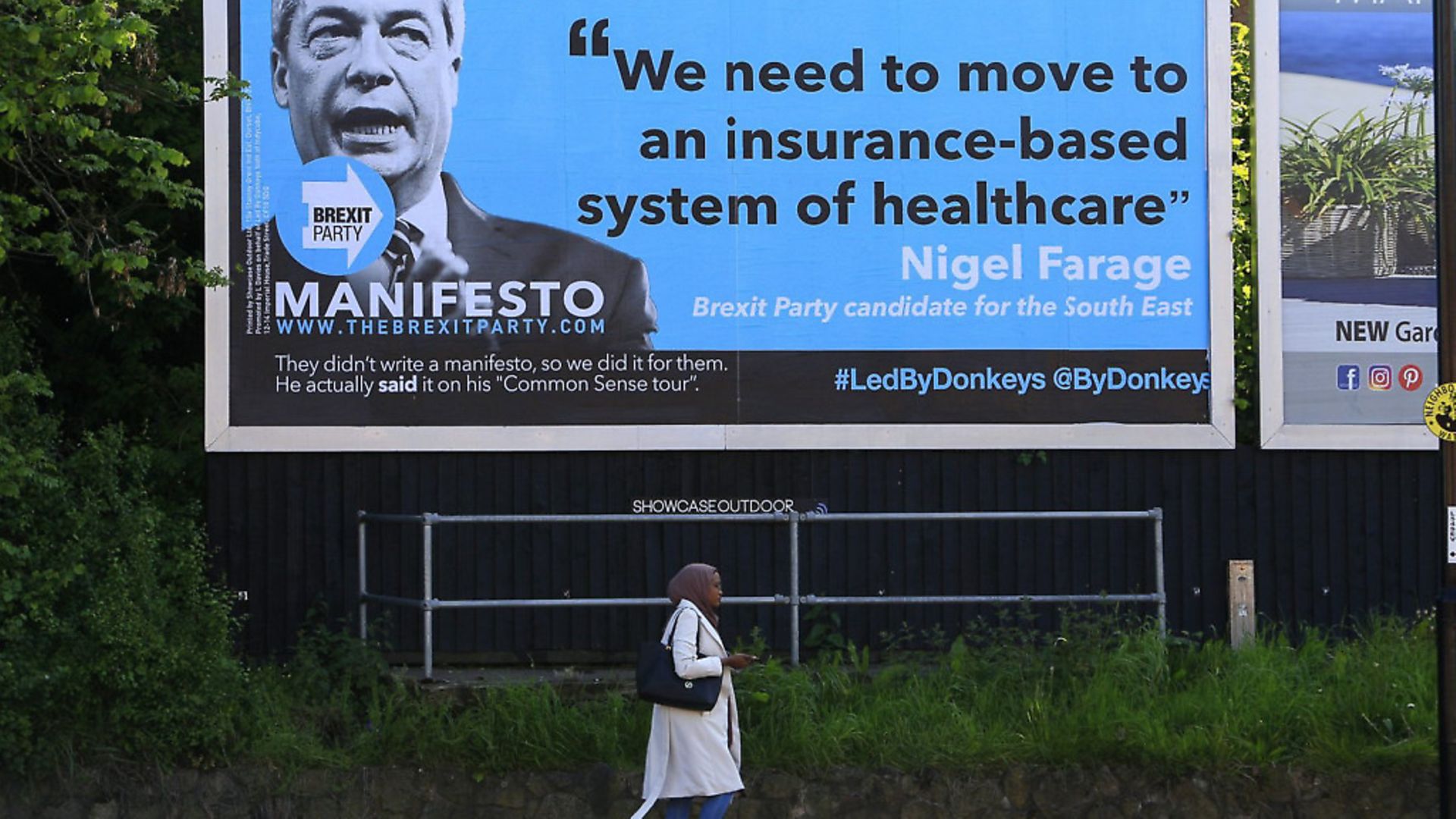 A woman walks past a billboard aimed at The Brexit Party leader Nigel Farage. Picture: Led By Donkeys - Credit: Led By Donkeys