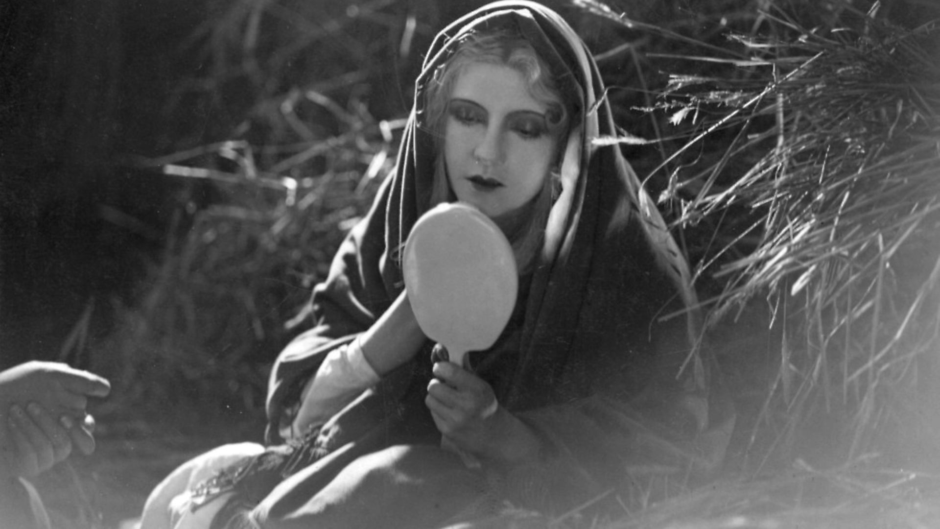 Brigitte Helm studies herself in the German silent film 'The Burning Mill'.  (Photo by Hulton Archive/Getty Images) - Credit: Getty Images