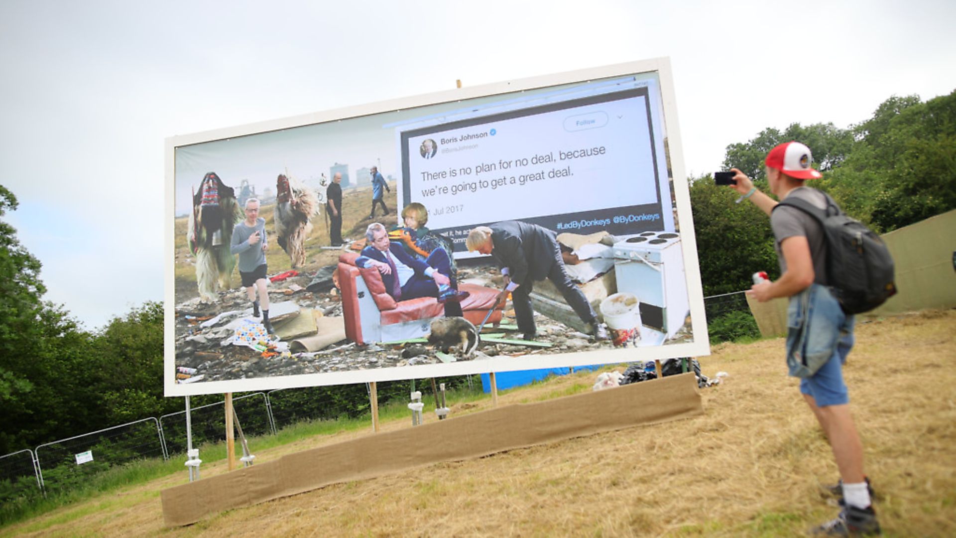 A collaboration billboard with Led by Donkeys and Cold War Steve after it is unveiled at the top of the park, on the first day of the Glastonbury Festival at Worthy Farm in Somerset. Photograph: Aaron Chown/PA. - Credit: PA Wire/PA Images