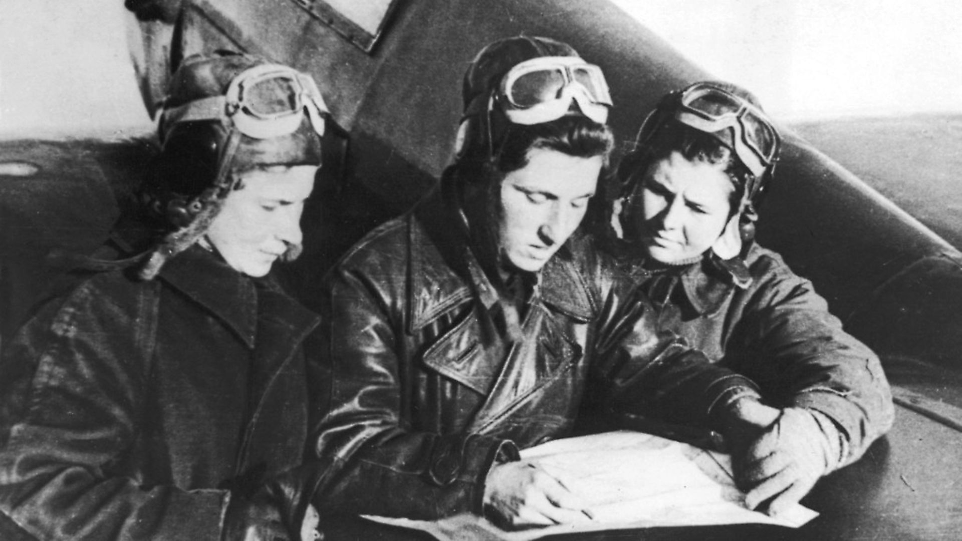 Russian female fighter pilots Lilya Litvyak (1921 - 1943) (left), Katerina Budanova (1916 - 1943) (center), and Mariya Kuznetsova, all of the 437th fighter regiment, plot their flight plans on the tailplane of a Yakovlev Yak-1 fighter plane, Russia, mid 1942. (Photo by Mansell/The LIFE Picture Collection via Getty Images/Getty Images) - Credit: The LIFE Picture Collection via