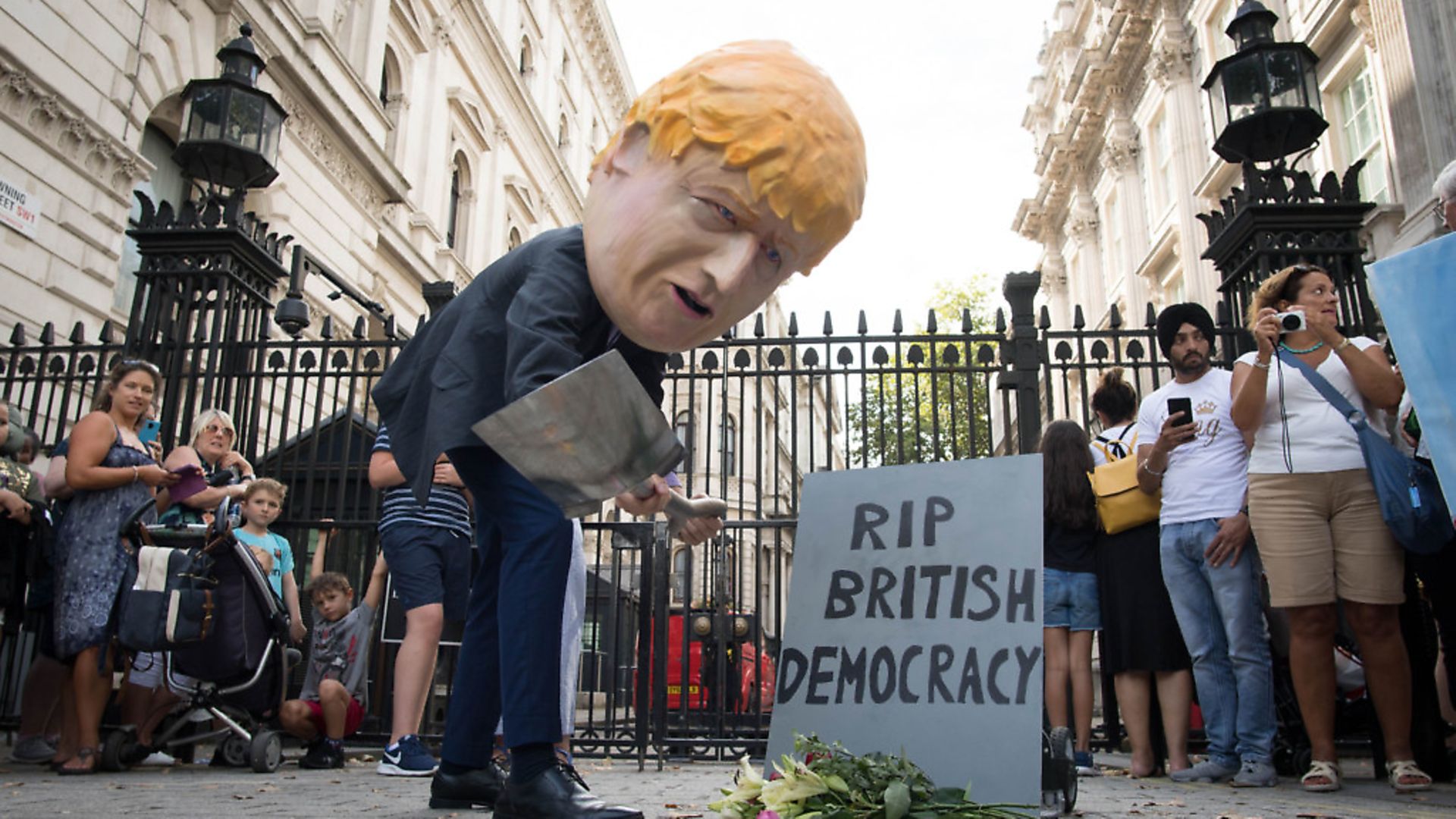 'Boris Johnson' digs a grave at the foot of a tombstone during a protest organised outside Downing Street in London. Photograph: Stefan Rousseau/PA Wire. - Credit: PA