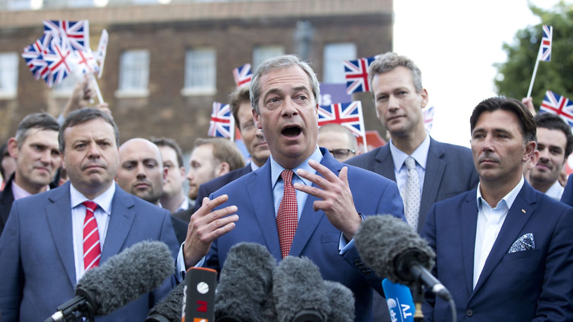 Arron Banks (L) and Andy Wigmore (R) as Nigel Farage gives a press conference at College Green after the referendum result. Photograph: Isabel Infantes/PA. - Credit: EMPICS Entertainment