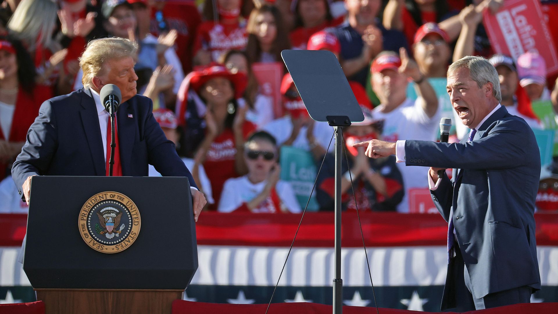 Nigel Farage (R) praises U.S. President Donald Trump during a campaign rally - Credit: Getty Images