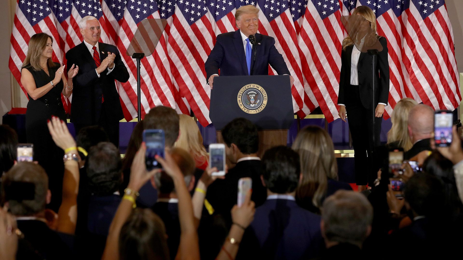 U.S. President Donald Trump speaks on election night in the East Room of the White House as First Lady Melania Trump, Vice President Mike Pence and Karen Pence look on - Credit: Getty Images