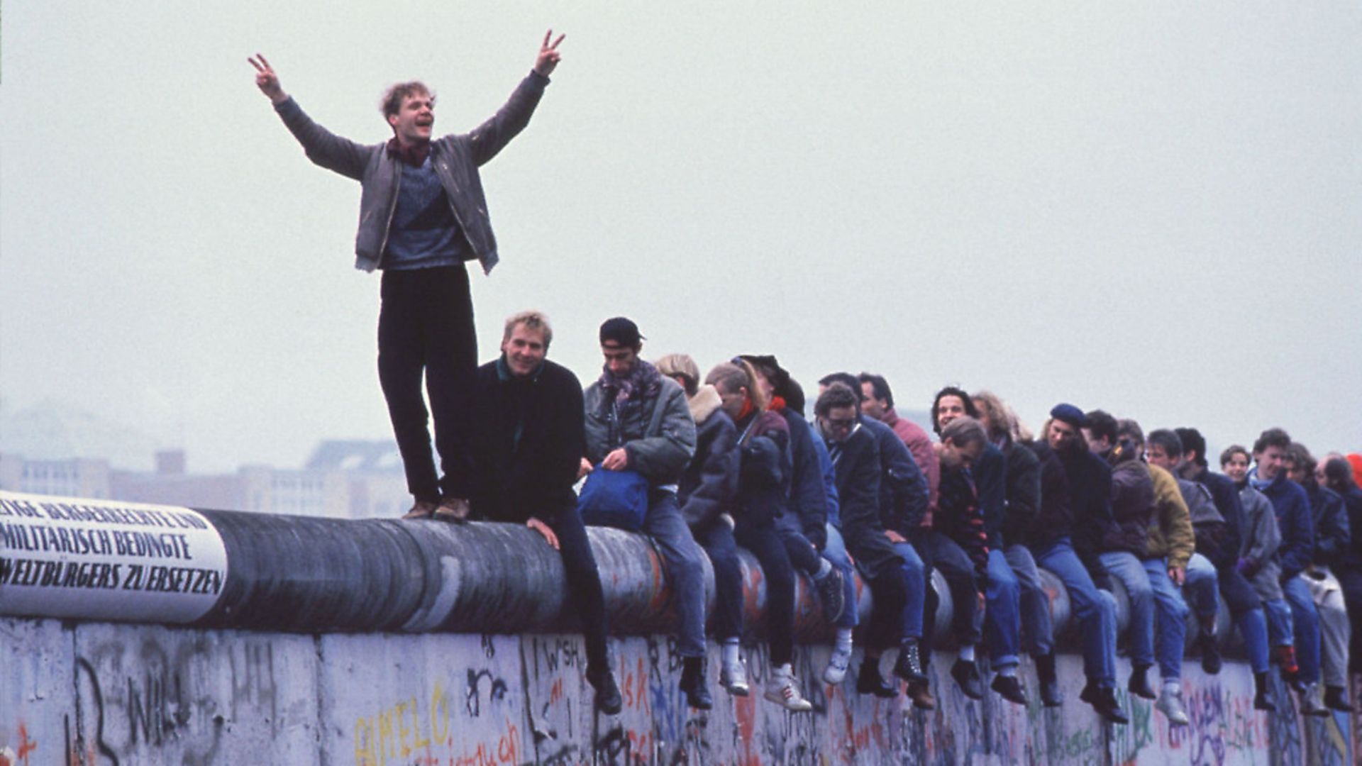 West Germans celebrate the unification of Berlin atop The Berlin Wall on November 12, 1989. Picture: Getty Images - Credit: Getty Images