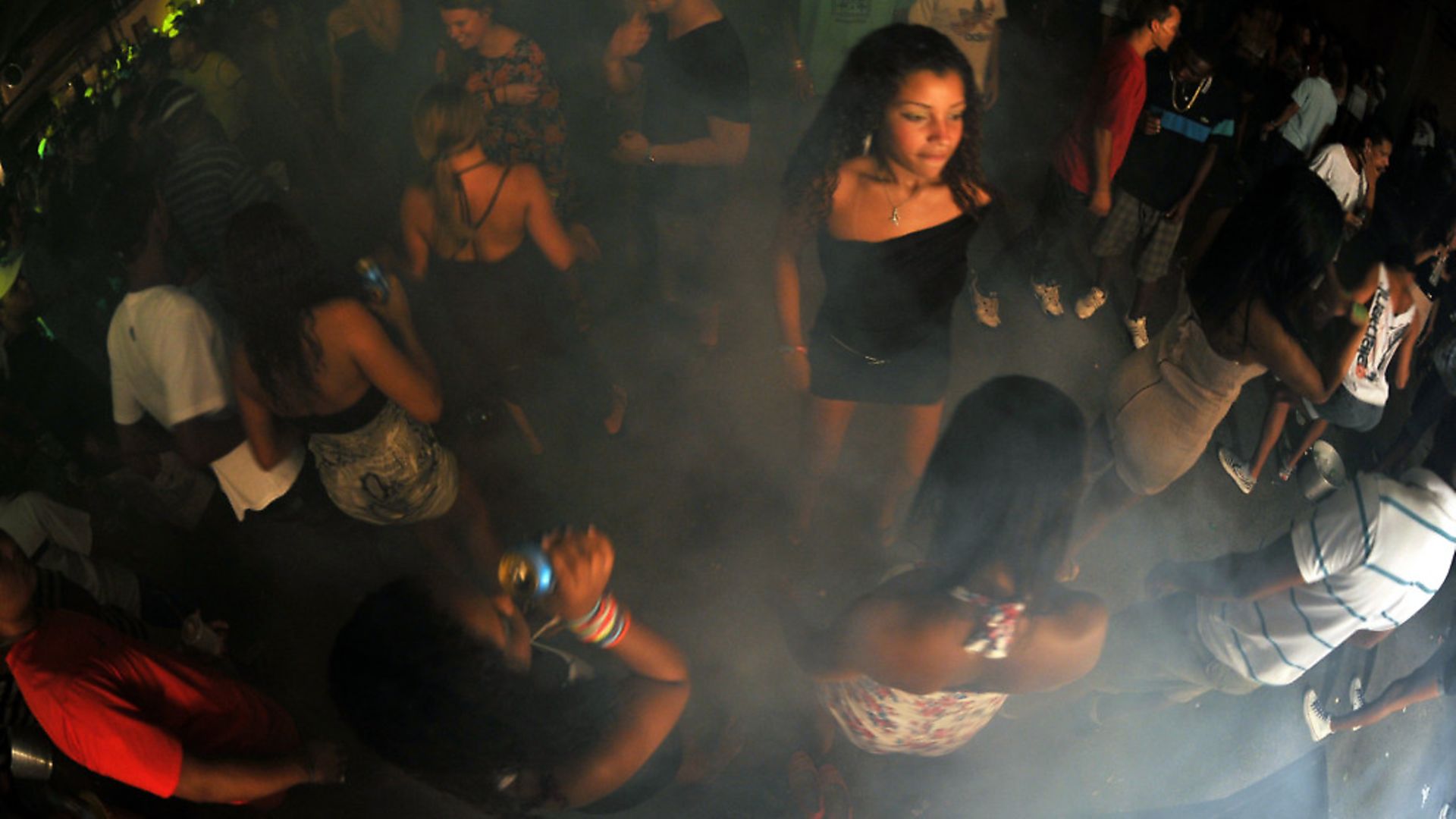 Brazilian youngsters enjoy a "Baile Funk" party at the Rocinha shantytown, in Rio de Janeiro, on March 25, 2012. In the last year, funk parties have been losing ground due to the police occupation in the favelas. AFP PHOTO / Christophe Simon (Photo credit should read CHRISTOPHE SIMON/AFP/Getty Images) - Credit: AFP/Getty Images