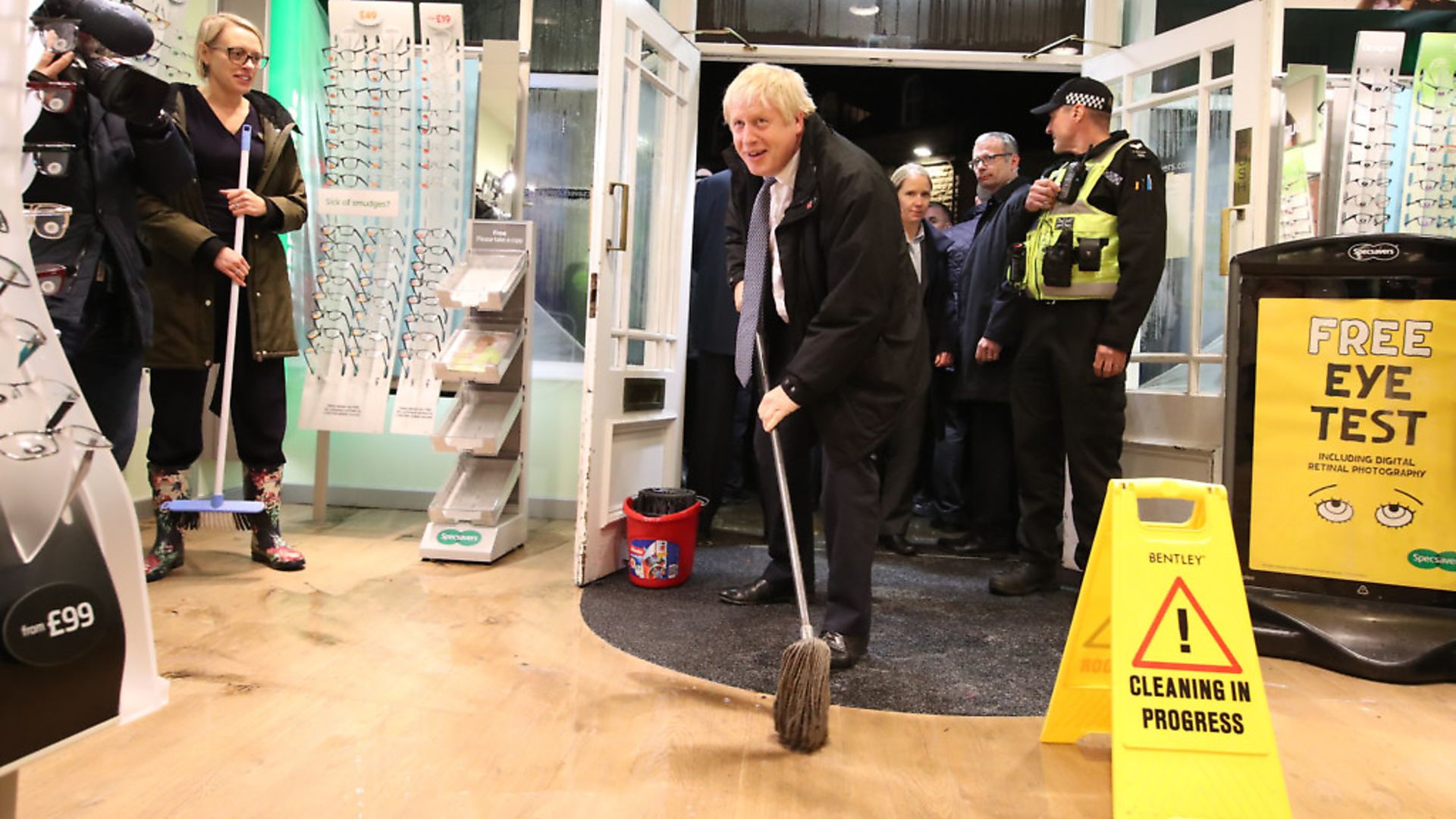 Boris Johnson "helps" with the clean up at an opticians as he visits Matlock, Derbyshire to view the flooding. Photograph: Danny Lawson/PA. - Credit: PA Wire/PA Images