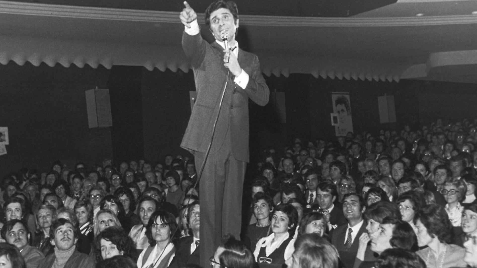 French singer and songwriter Gilbert Becaud (1927 - 2001) among the audience at the Olympia Theatre, Paris, 20th March 1973, during a concert to celebrate his twenty-year career. (Photo by Keystone/Hulton Archive/Getty Images) - Credit: Getty Images