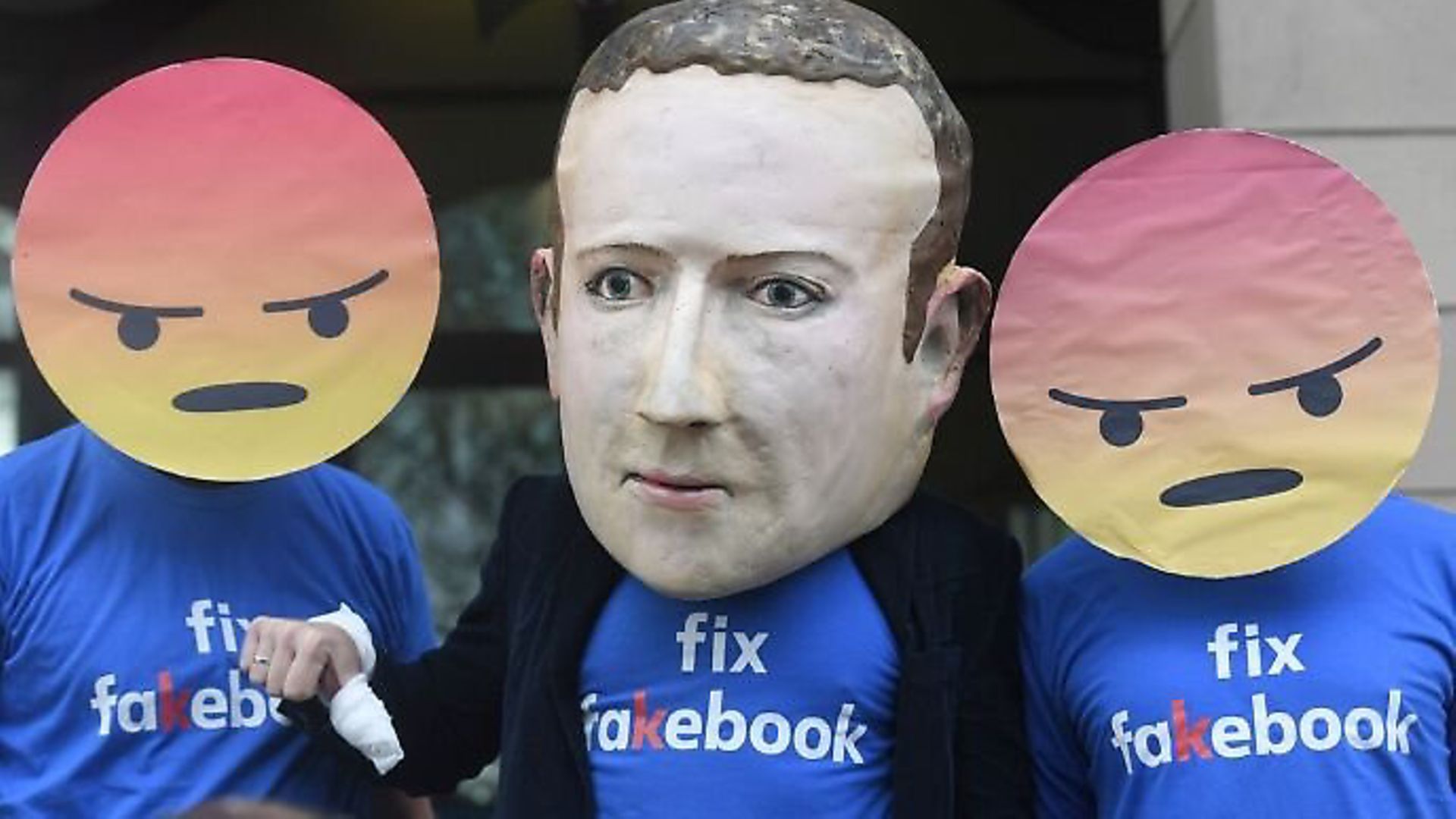 A Mark Zuckerberg figure with people in angry emoji masks outside Portcullis House in Westminster ahead of DCMS inquiry into fake news. Photograph: Victoria Jones/PA. - Credit: Archant