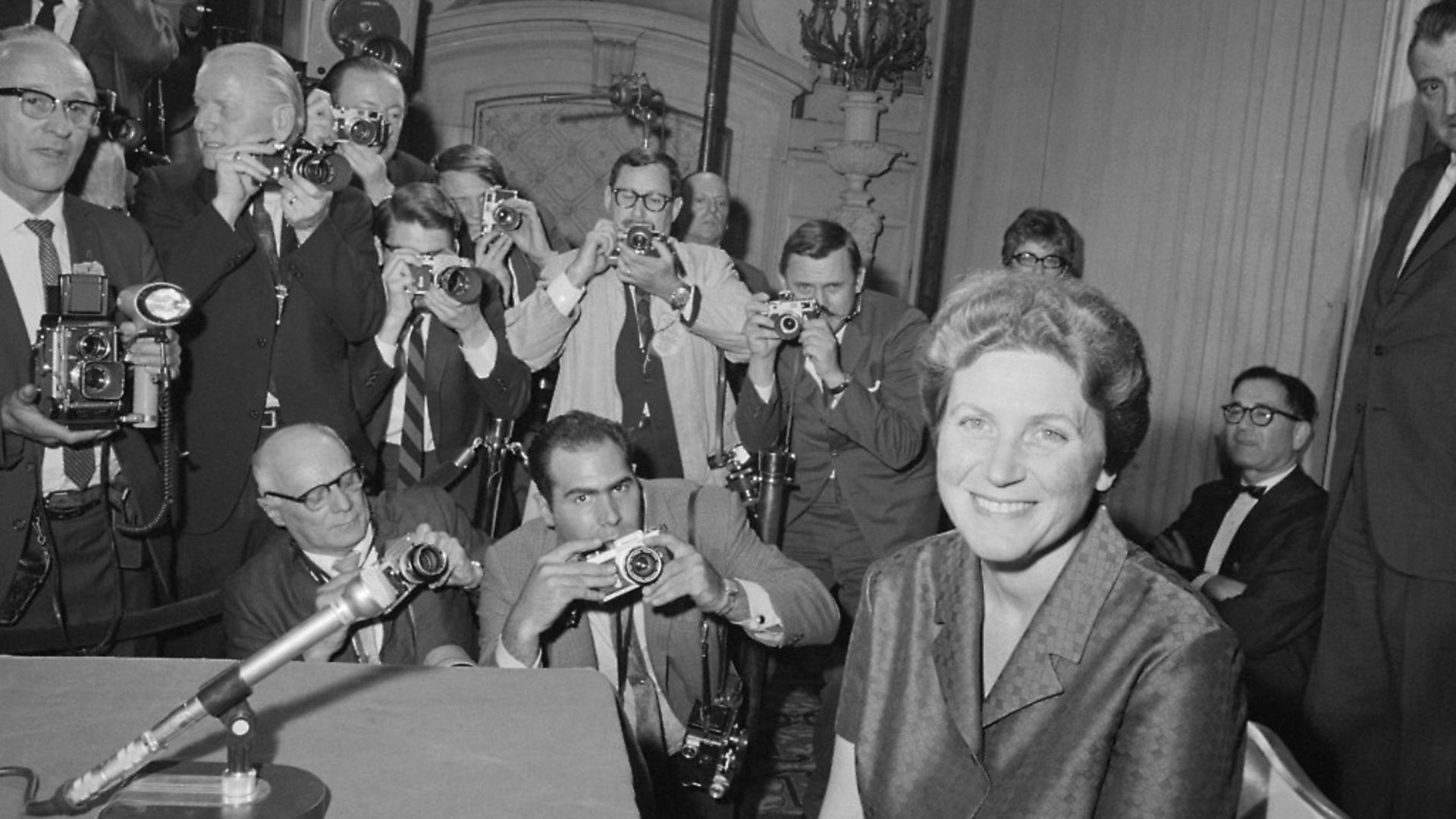 (Original Caption) Say Cheese. New York: Svetlana Alliluyeva, daughter of the late Russian dictator, Josef Stalin, smiles for photographers at her press conference here April 26. - Credit: Bettmann Archive