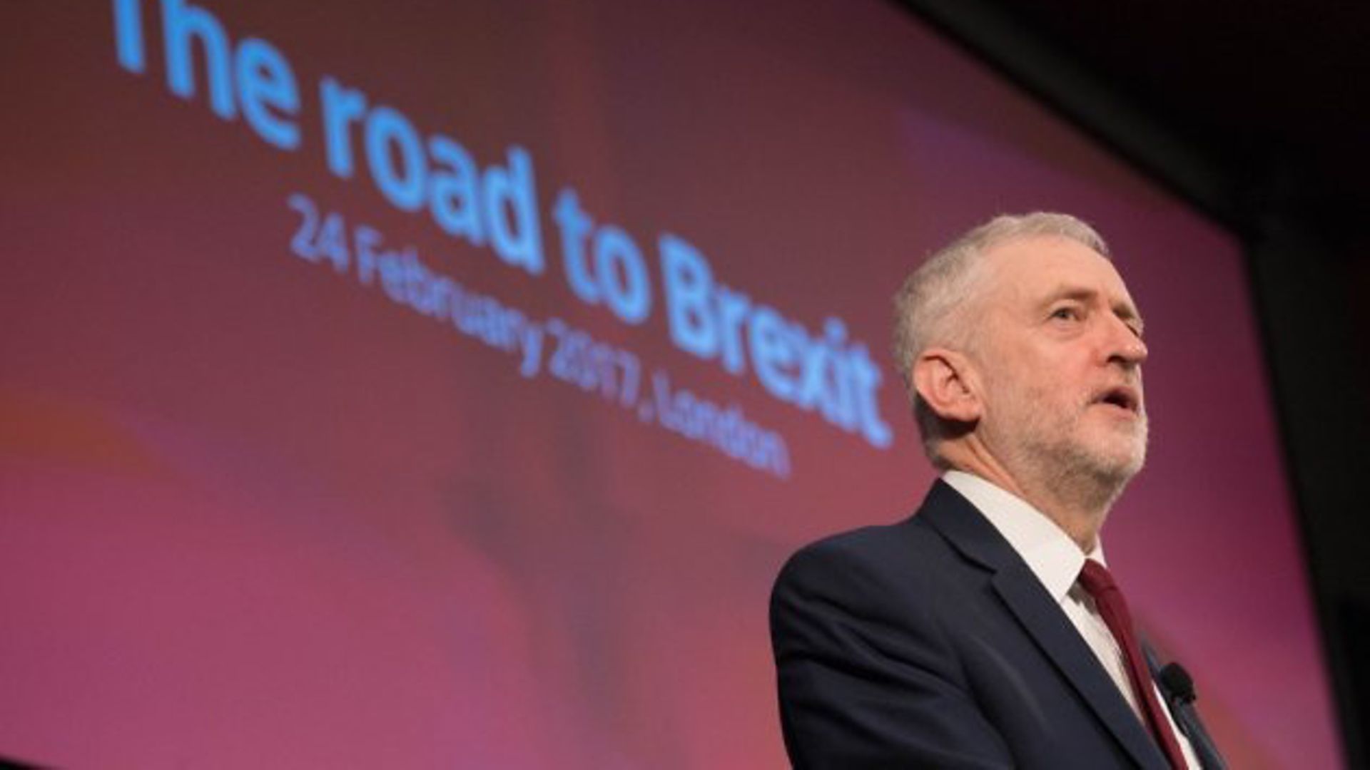 Jeremy Corbyn addresses crowds stood in front of a 'road to Brexit' backdrop - Credit: PA