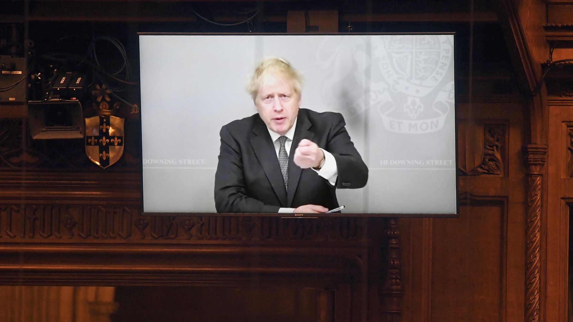 Prime Minister Boris Johnson appearing via video link from 10 Downing Street during Prime Minister's Questions in the House of Commons - Credit: PA