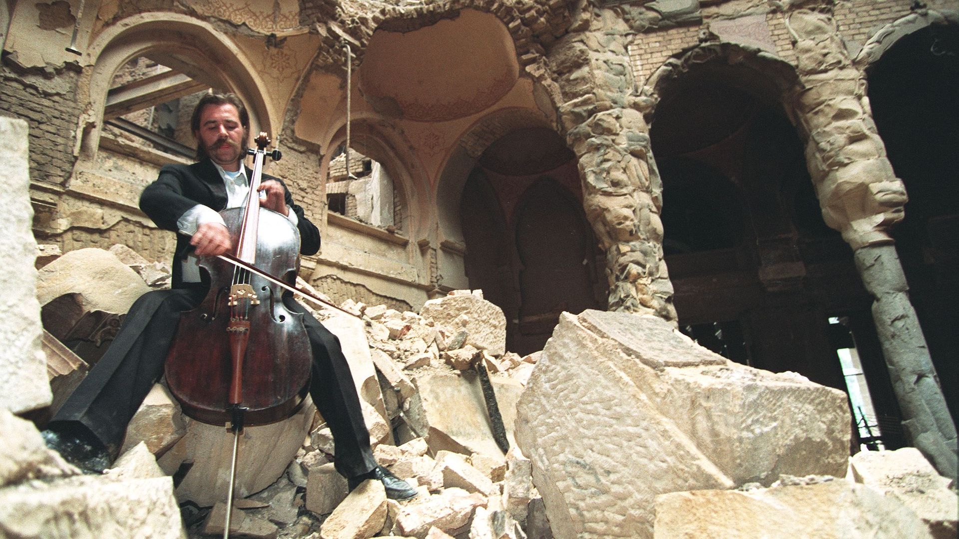 Cellist Vedran Smailovic playing Strauss in the bombed National Library in Sarajevo, in September 1992 shows. (Photo credit should read MICHAEL EVSTAFIEV/AFP via Getty Images) - Credit: AFP via Getty Images