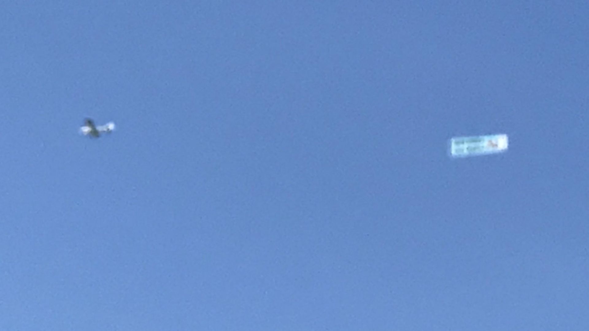 The small plane is towing a banner which reads Remainers are Kaput, in black and white, with a red hammer and sickle also shown. Photo: Twitter - Credit: Archant