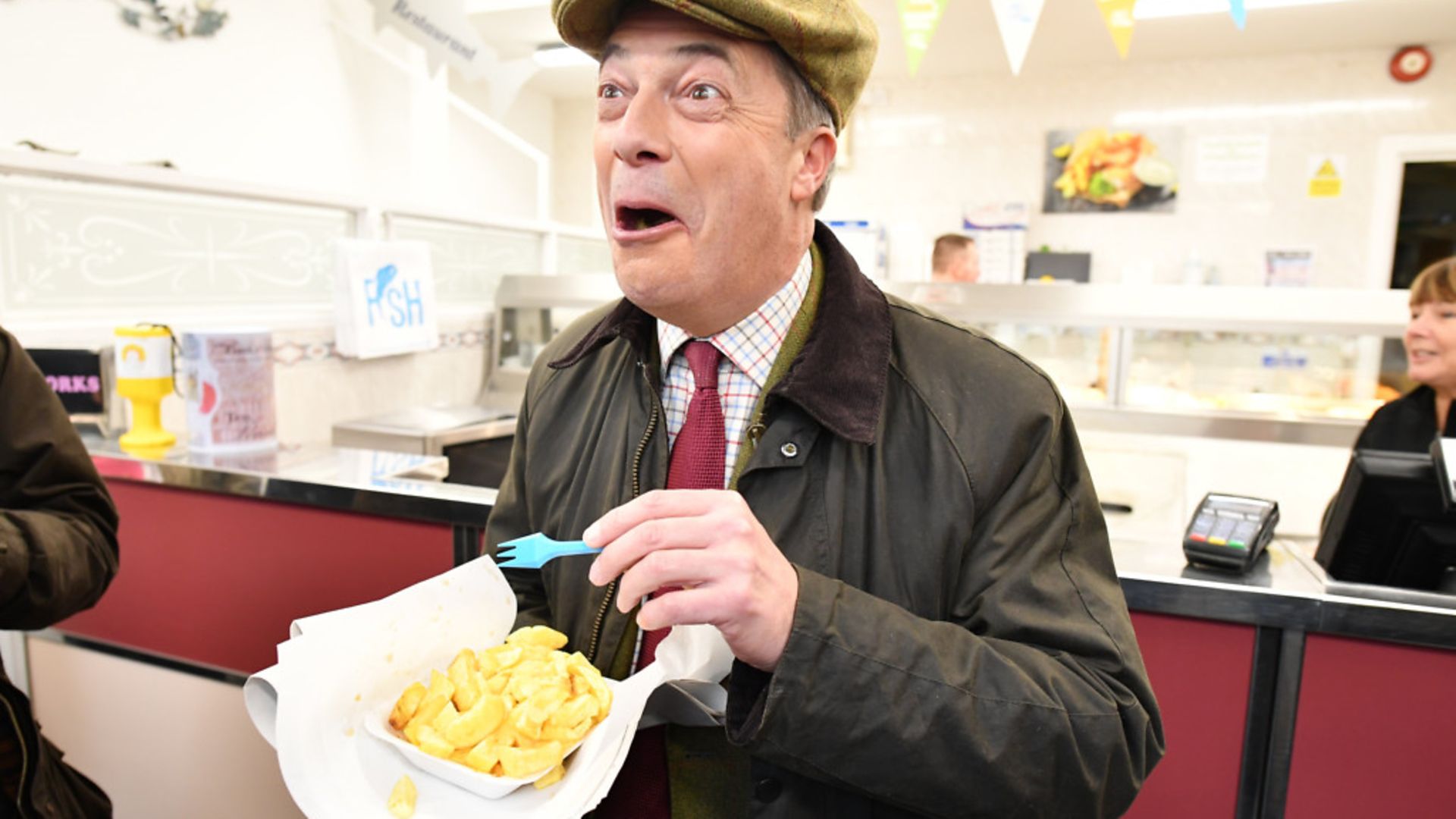 Brexit Party leader Nigel Farage eats fish and chips in Whitehaven - Credit: Getty Images