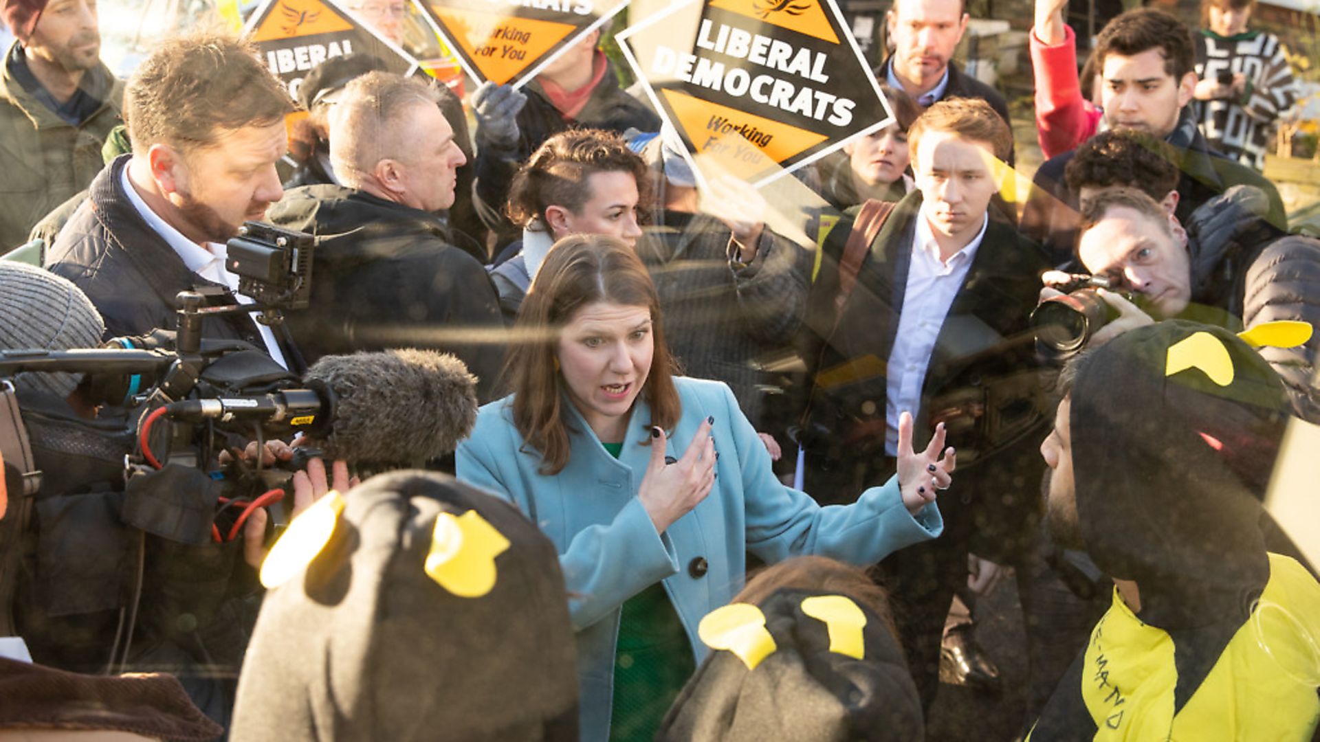 Extinction Rebellion protesters dressed as bees glue themselves to the Lib Dems battle bus during a visit to Knights Youth Centre in London. Photograph: Aaron Chown/PA Wire. - Credit: PA