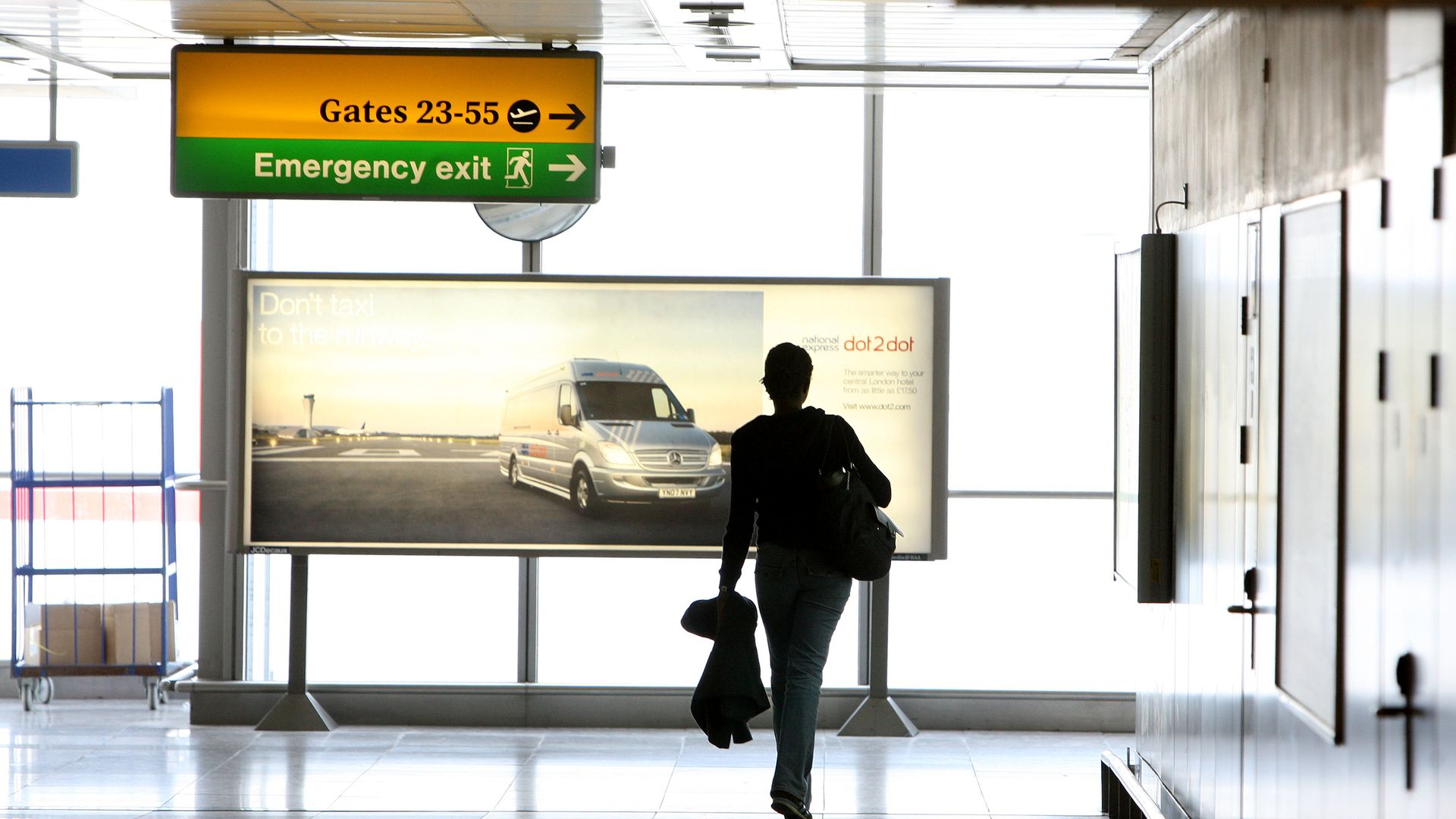 A picture of a passenger walking between departure gates in Terminal 3 at Heathrow Airport - Credit: PA