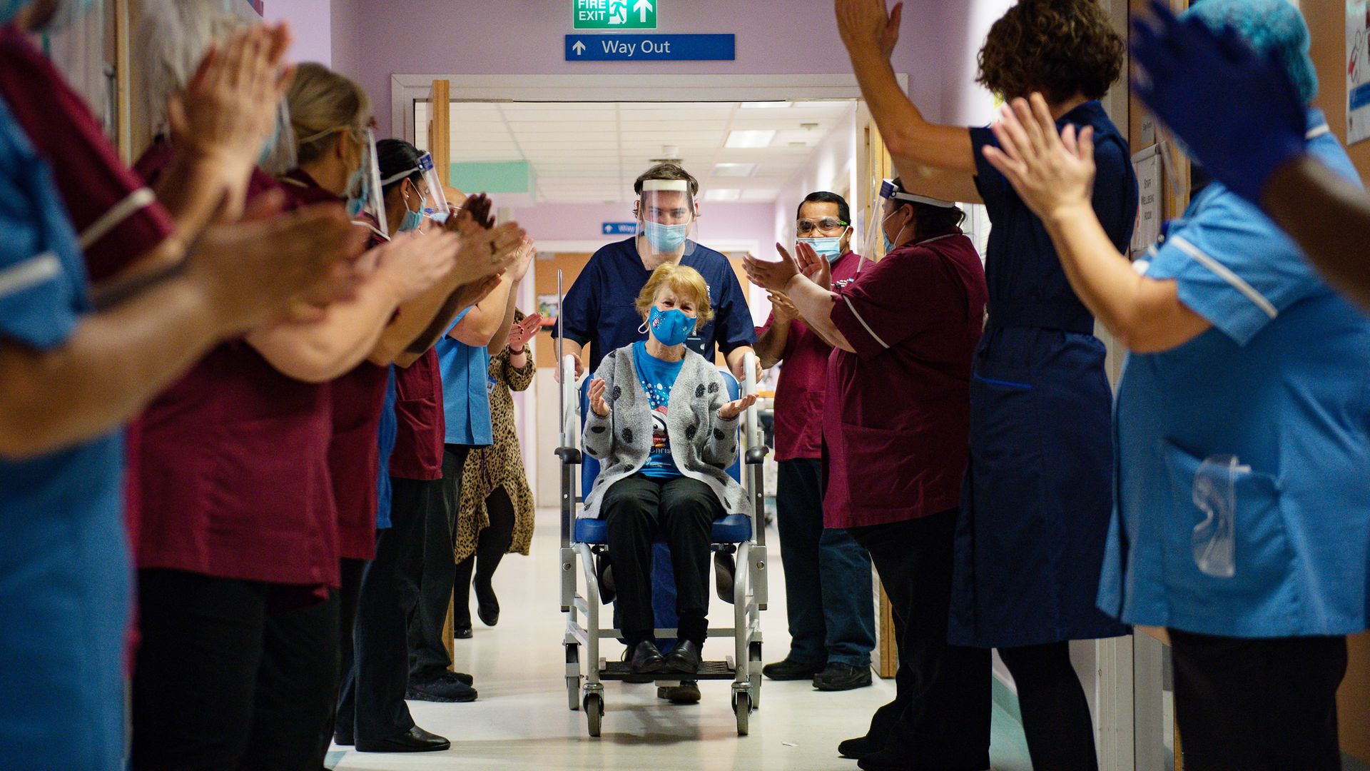 Margaret Keenan, 90, is applauded by staff as she returns to her ward after becoming the first person in the United Kingdom to receive the Pfizer/BioNtech covid-19 vaccine at University Hospital, Coventry, at the start of the largest ever immunisation programme in the UK's history. - Credit: PA