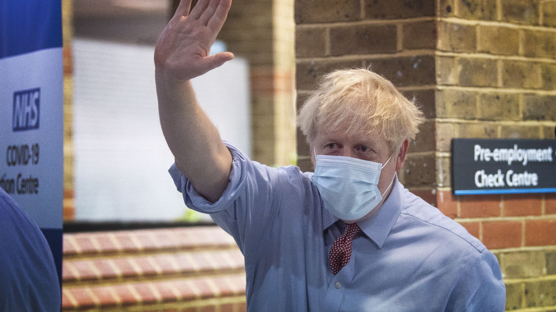 Prime minister Boris Johnson waves as he leaves Guy's Hospital in London, after watching a patient receive a Covid-19 vaccination jab on the first day of the largest immunisation programme in the UK's history - Credit: PA