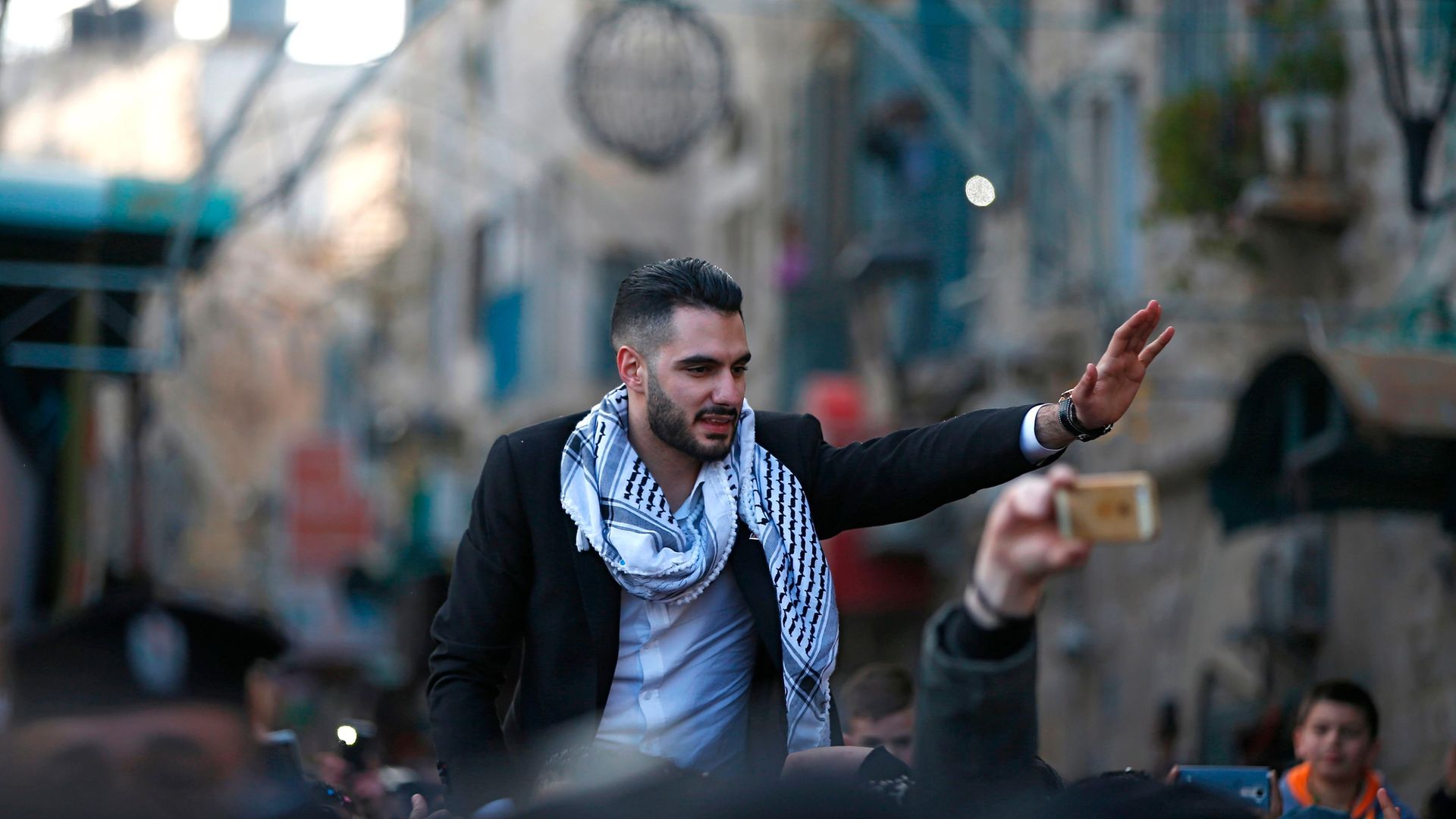 Yacoub Shaheen is greeted by crowds in his hometown of Bethlehem after winning Arab Idol in 2017 - Credit: AFP via Getty Images