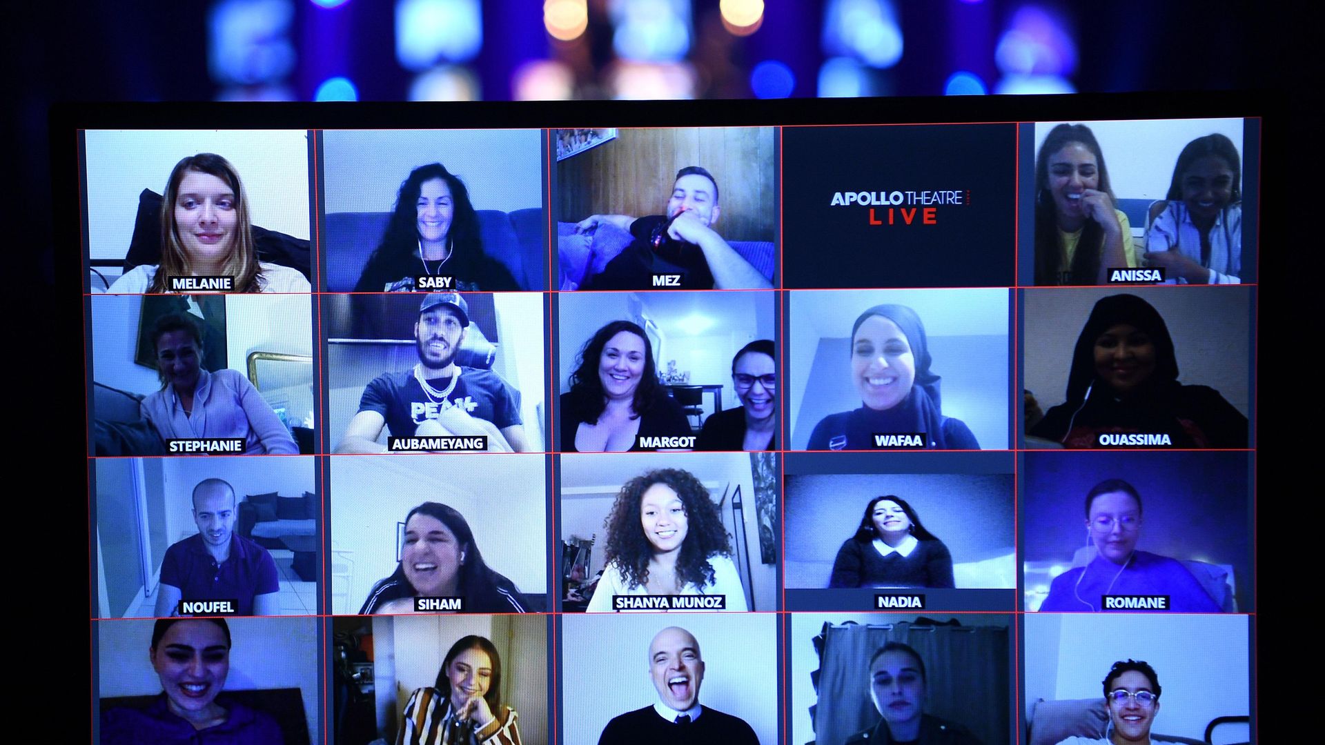 Viewers watch the live streaming of French humorists Othman and Kalvin at the Apollo Theatre in Paris - Credit: AFP via Getty Images