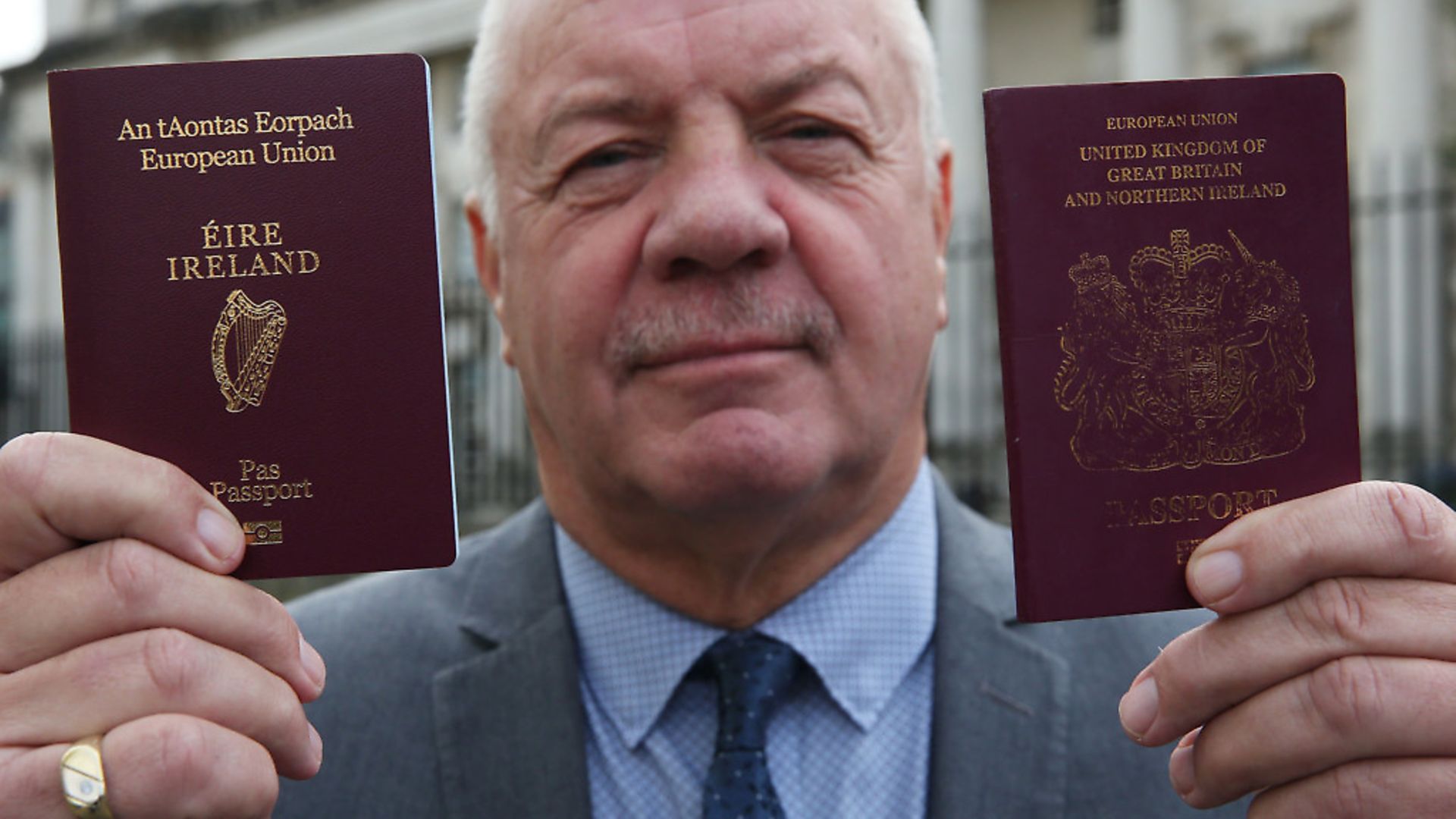 Raymond McCord holds up his newly issued Irish passport. Photograph: Brian Lawless/PA. - Credit: PA Archive/PA Images