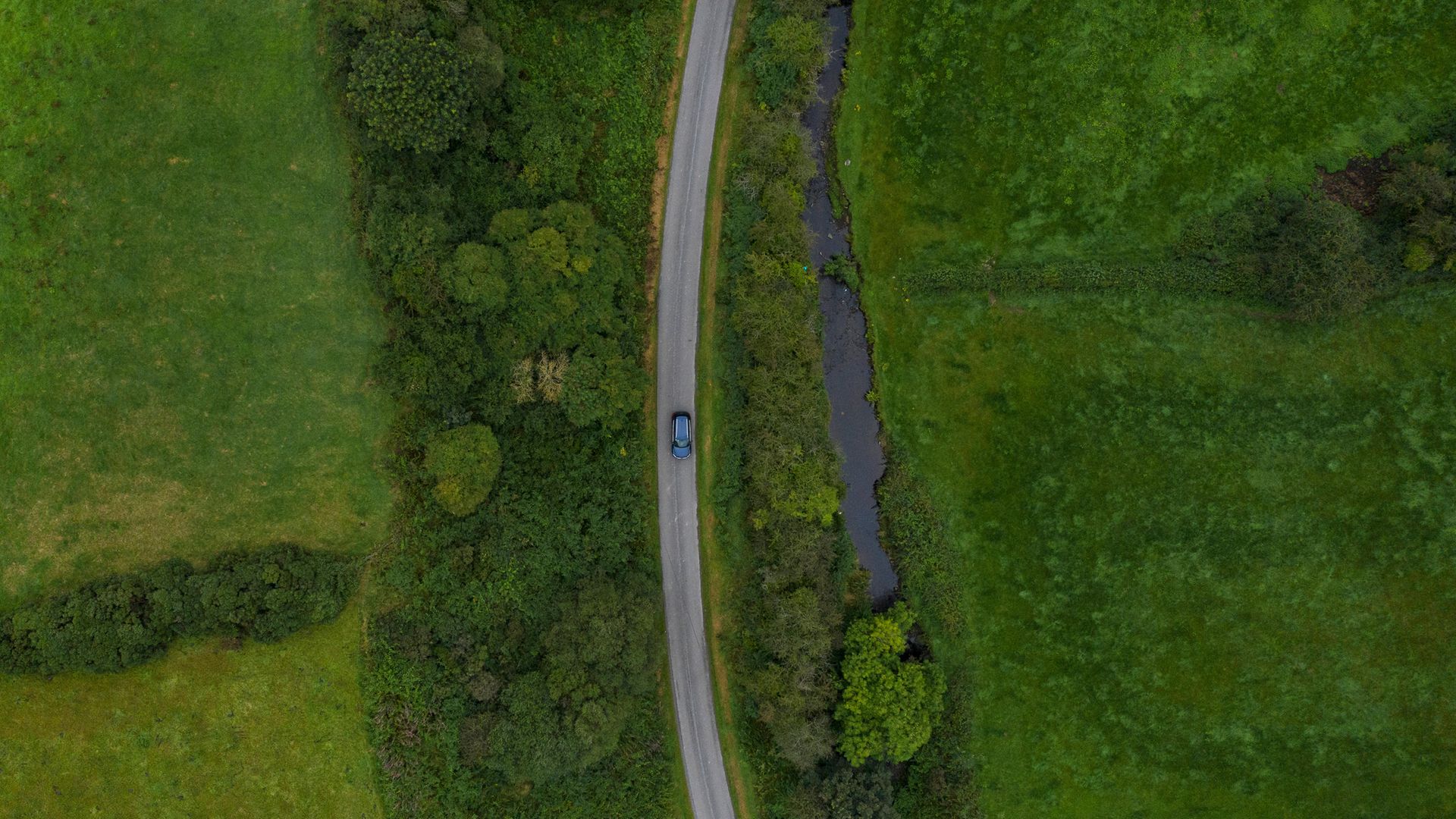 A road runs along a stream that marks the border between Northern Ireland (left) and Ireland, at Castleblayney - Credit: Getty Images