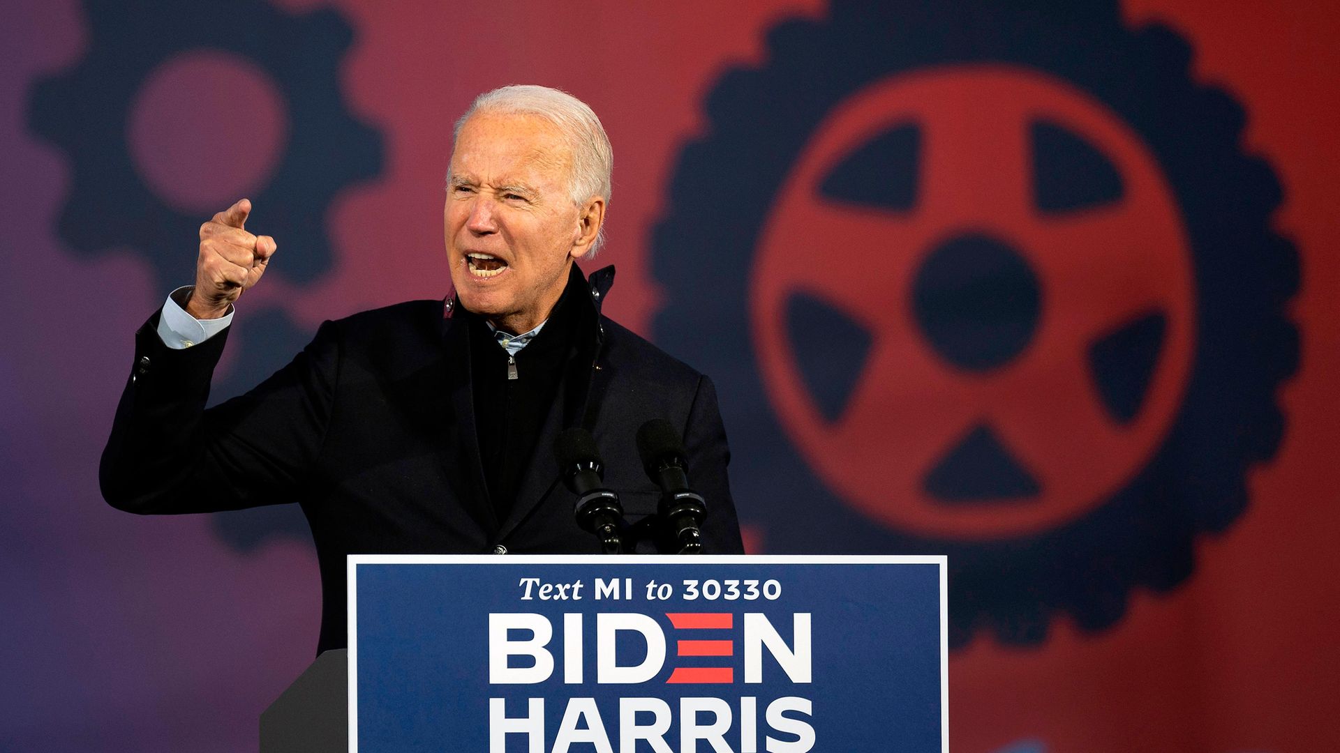 Joe Biden speaks at a car rally at the Michigan State Fairgrounds in Detroit - Credit: AFP via Getty Images