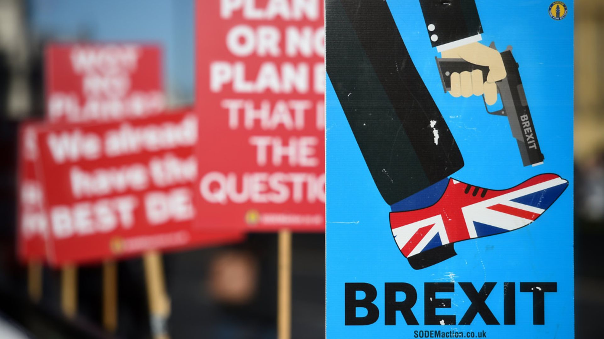 Anti-Brexit campaigners' placards outside the Houses of Parliament - Credit: PA Wire/PA Images